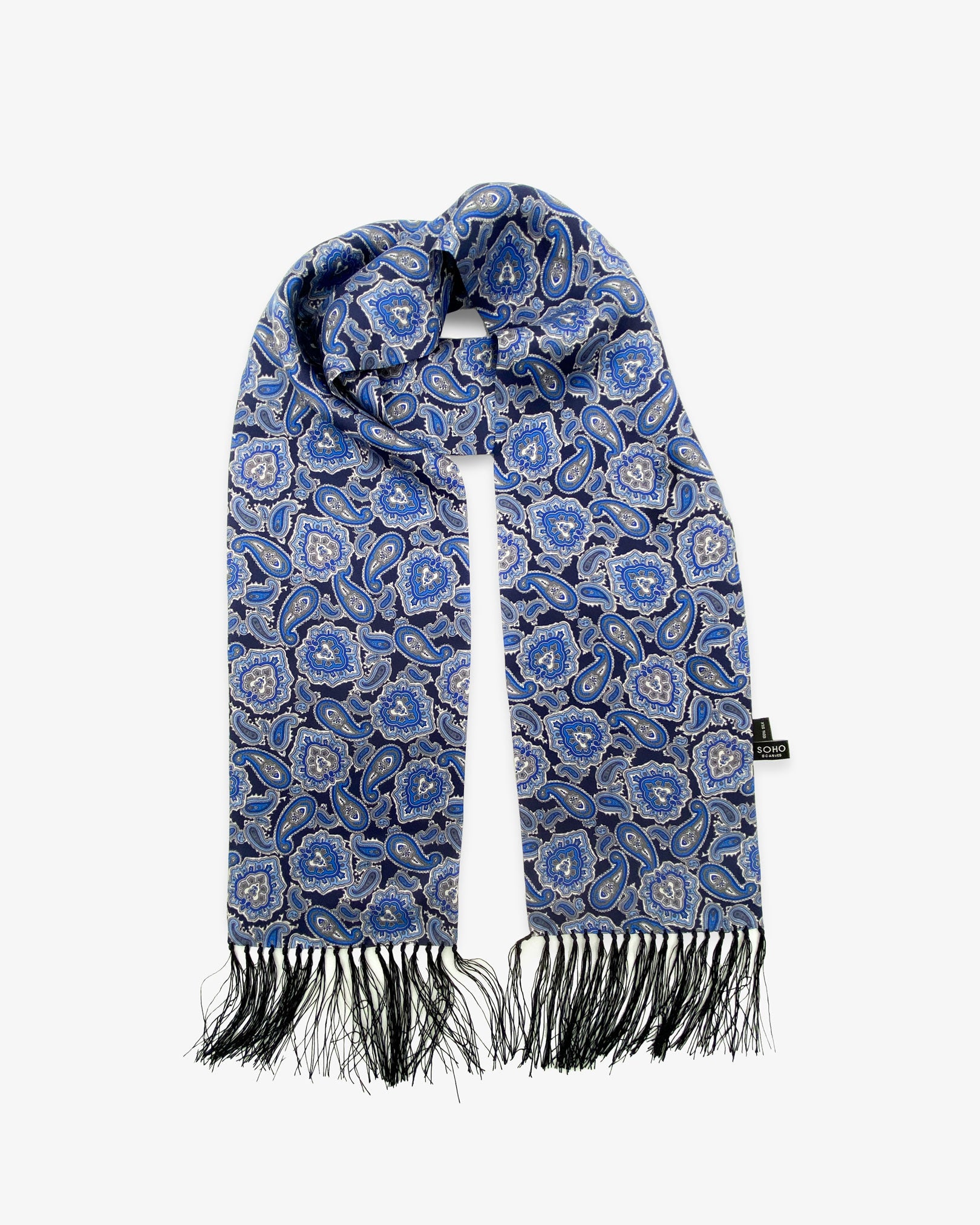 The Dezon pure silk aviator scarf looped in middle with both ends parallel showing the blue paisley patterns with matching 3-inch fringe.