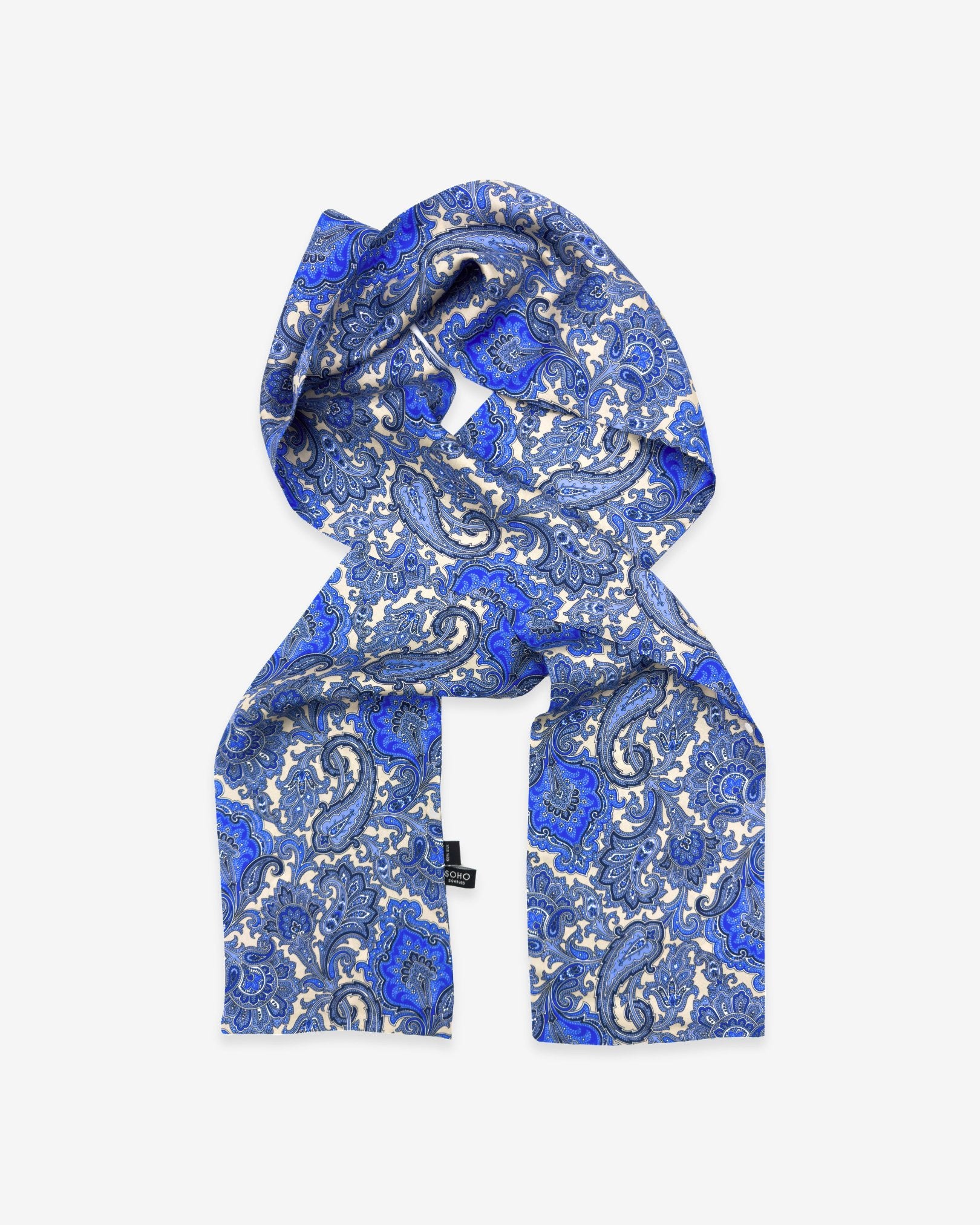 'The Piccadilly' polyester scarf folded in a rectangular shape with dark, mid and light blue paisley patterns.