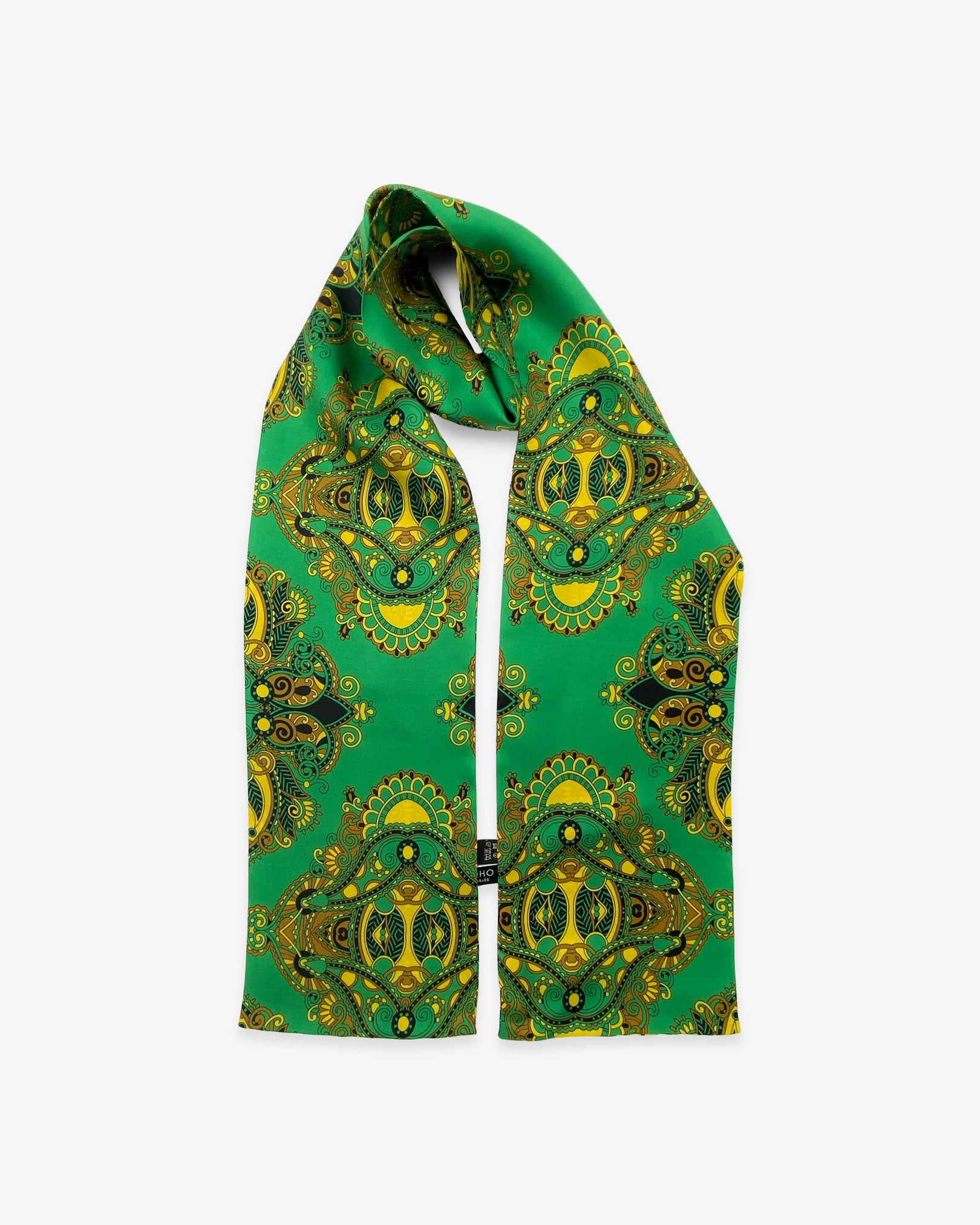 The Forks pure silk scarf looped in middle with both ends parallel, showing paisley-inspired patterns on an emerald-green ground