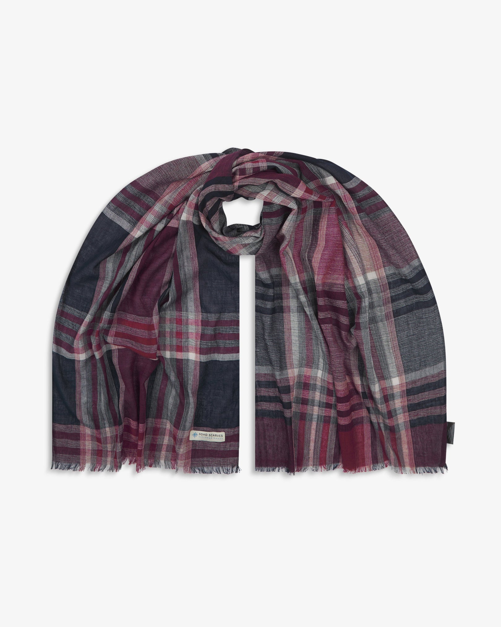 The 'Hillary' cotton plaid scarf, looped in middle with both ends parallel. Displaying the tartan pattern of navy, red, and grey yarns and the SOHO Scarves Explorer Range branding logo in the bottom-left.