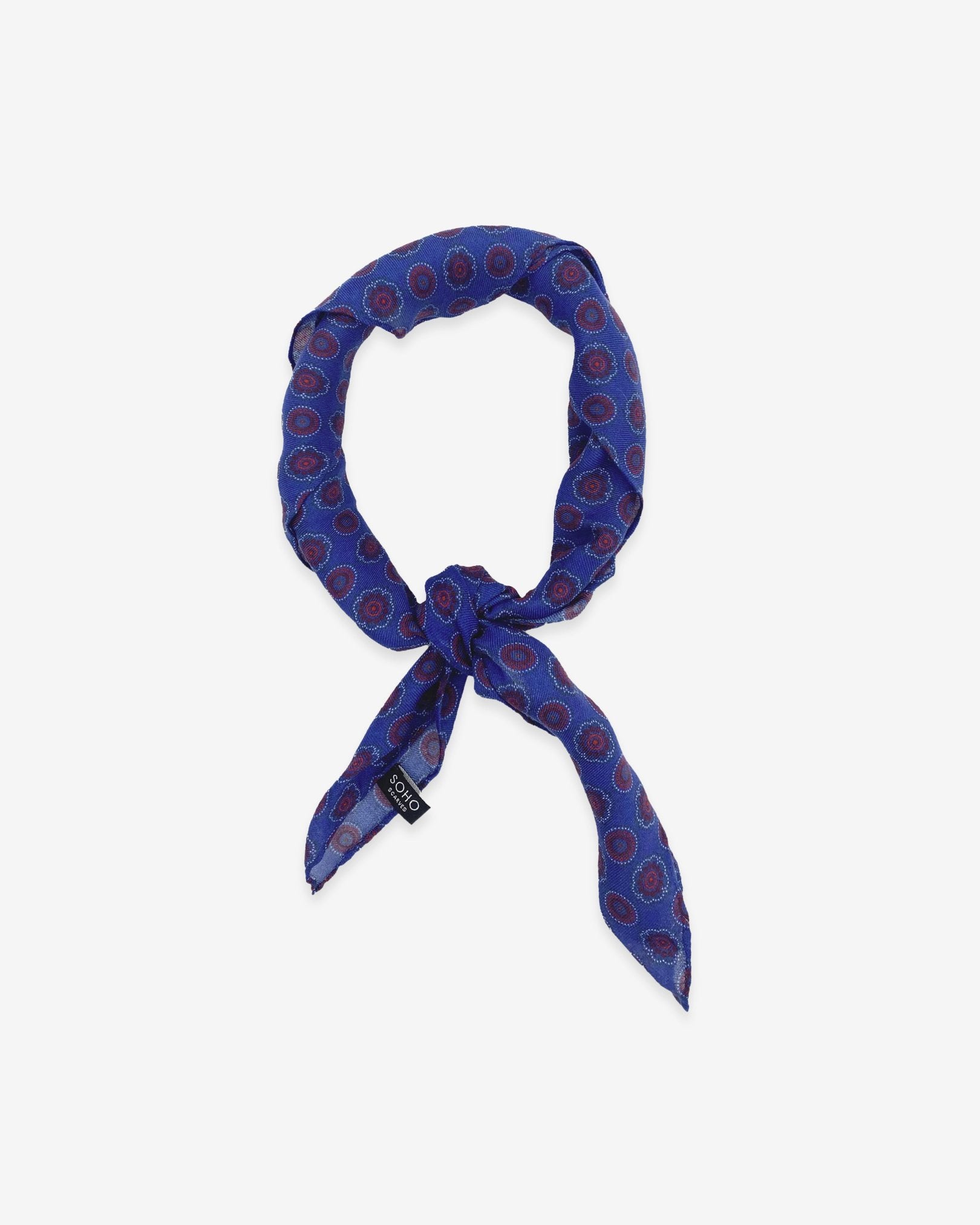 The Bellevue blue and red patterened bandana knotted into a loop on a white background.