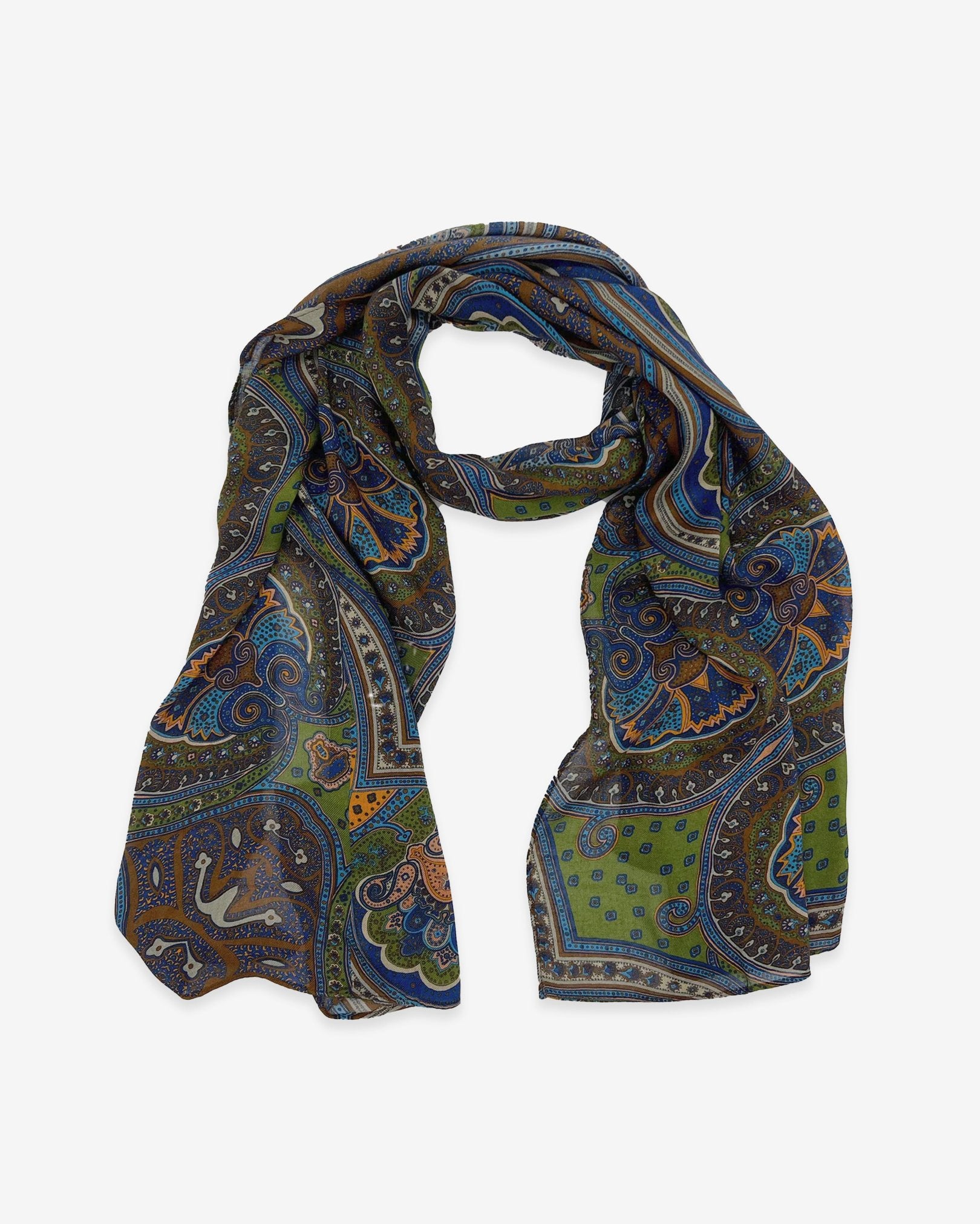 The Montreal multicoloured paisley-patterned bohemian wide scarf in appealing earthy tones. Knotted into a loop on a white background.