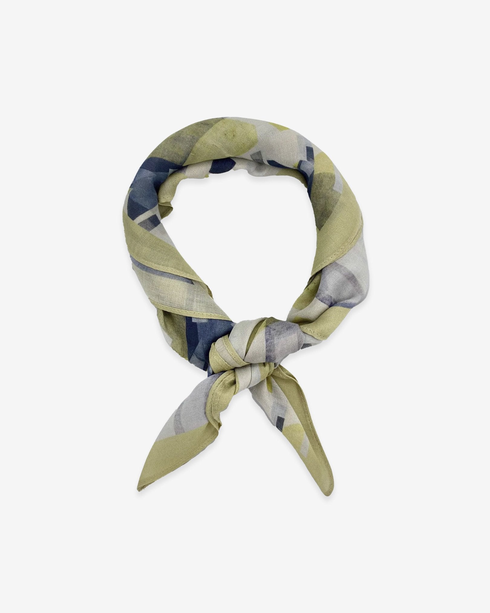 The Nevada bandana knotted loosely into a loop, showing the muted yellow and grey tones of the modal-wool fabric.