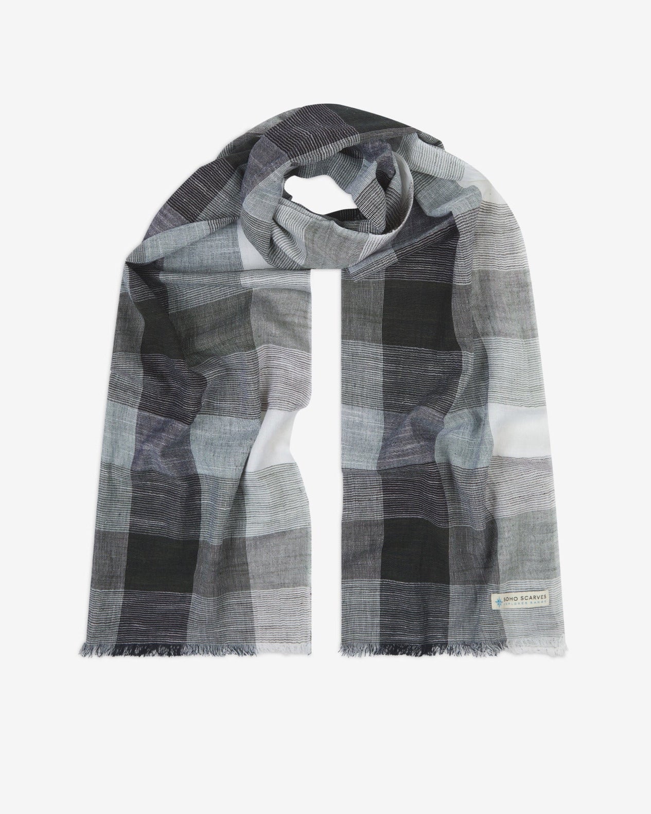 The 'Livingstone' cotton plaid scarf, looped in middle with both ends parallel. Displaying the checkered pattern of greys and white, and the SOHO Scarves Explorer Range branding logo in the bottom-right.