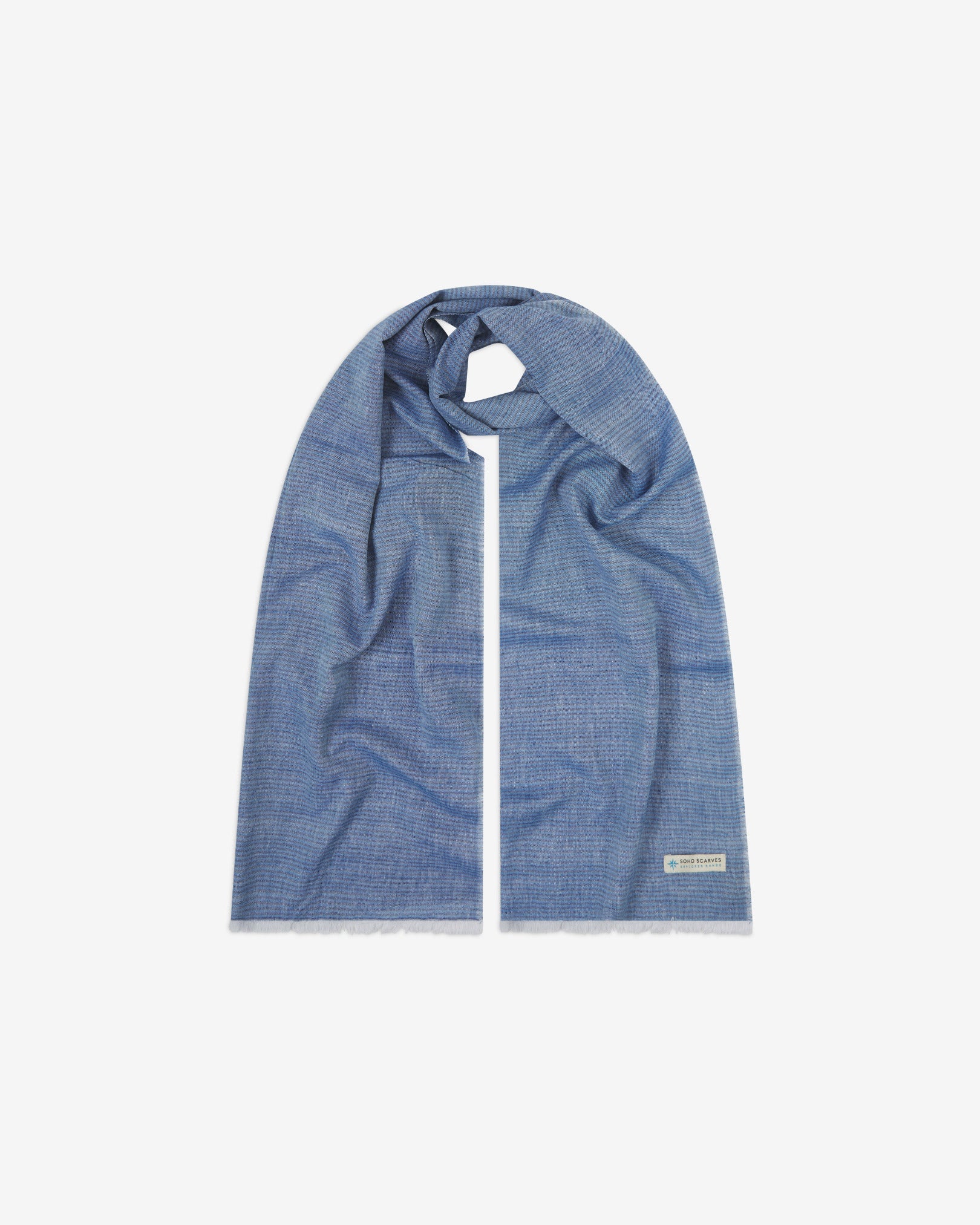 The 'MacArthur' cotton heathered scarf, looped in middle with both ends parallel. Displaying the blue heathered fabric and the SOHO Scarves Explorer Range branding logo in the bottom-right.