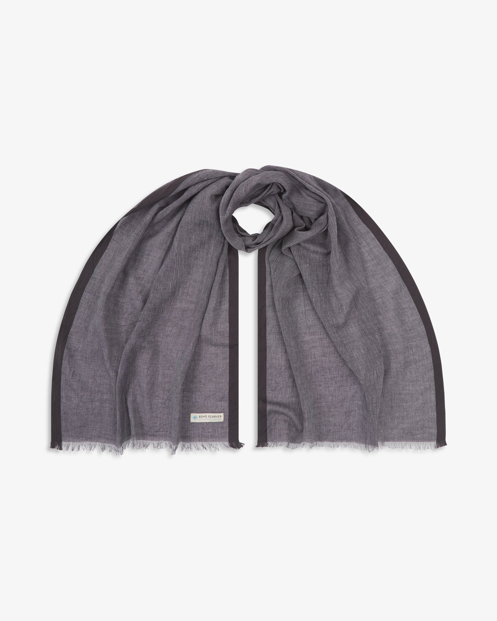 The 'Messner' cotton plaid scarf, looped in middle with both ends parallel. Displaying the brown yarns and the SOHO Scarves Explorer Range branding logo in the bottom-left.