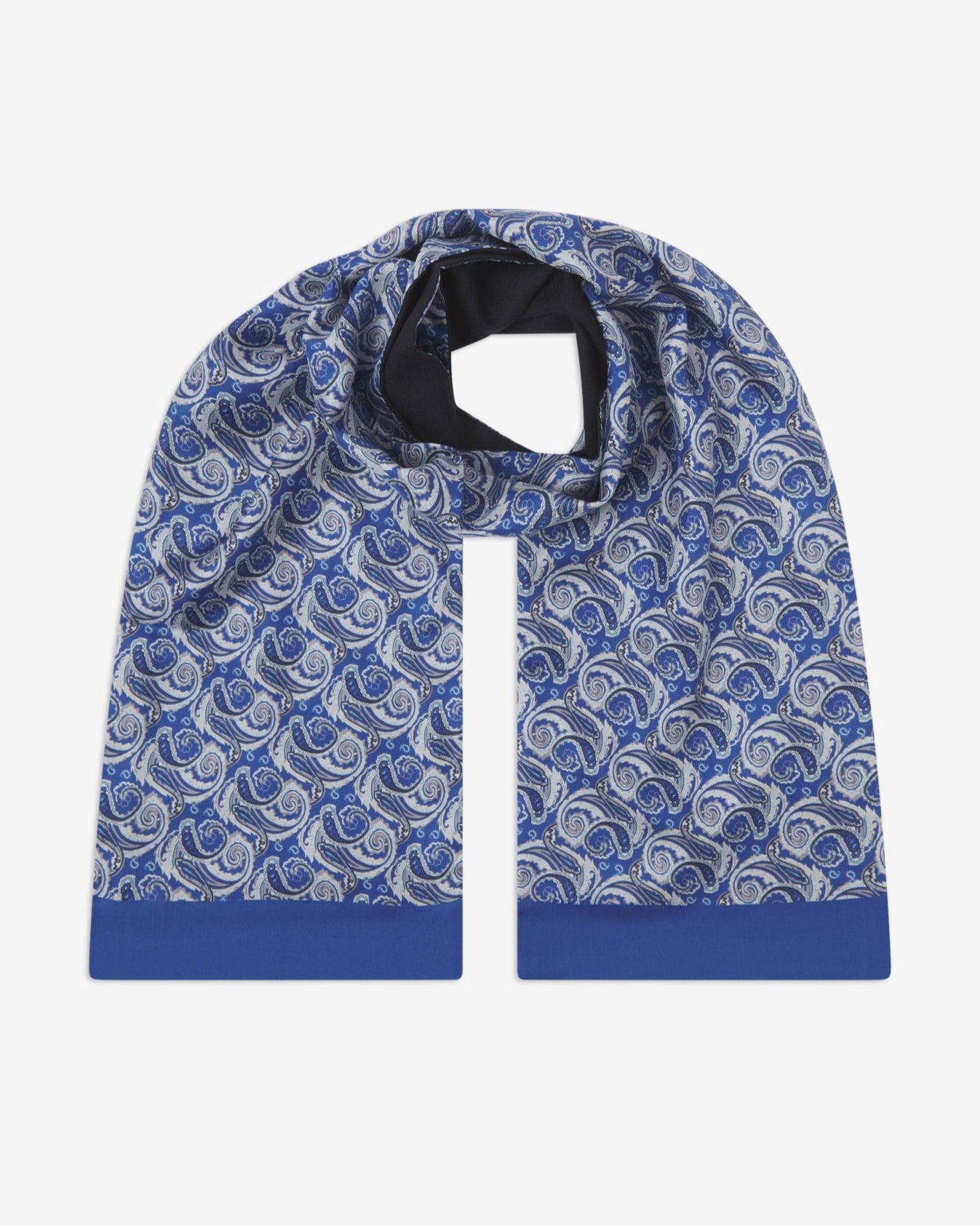 The Renton wool-backed silk scarf. Unravelled and looped in the middle, showing the length, width, pattern on silk and the fine woollen underside.