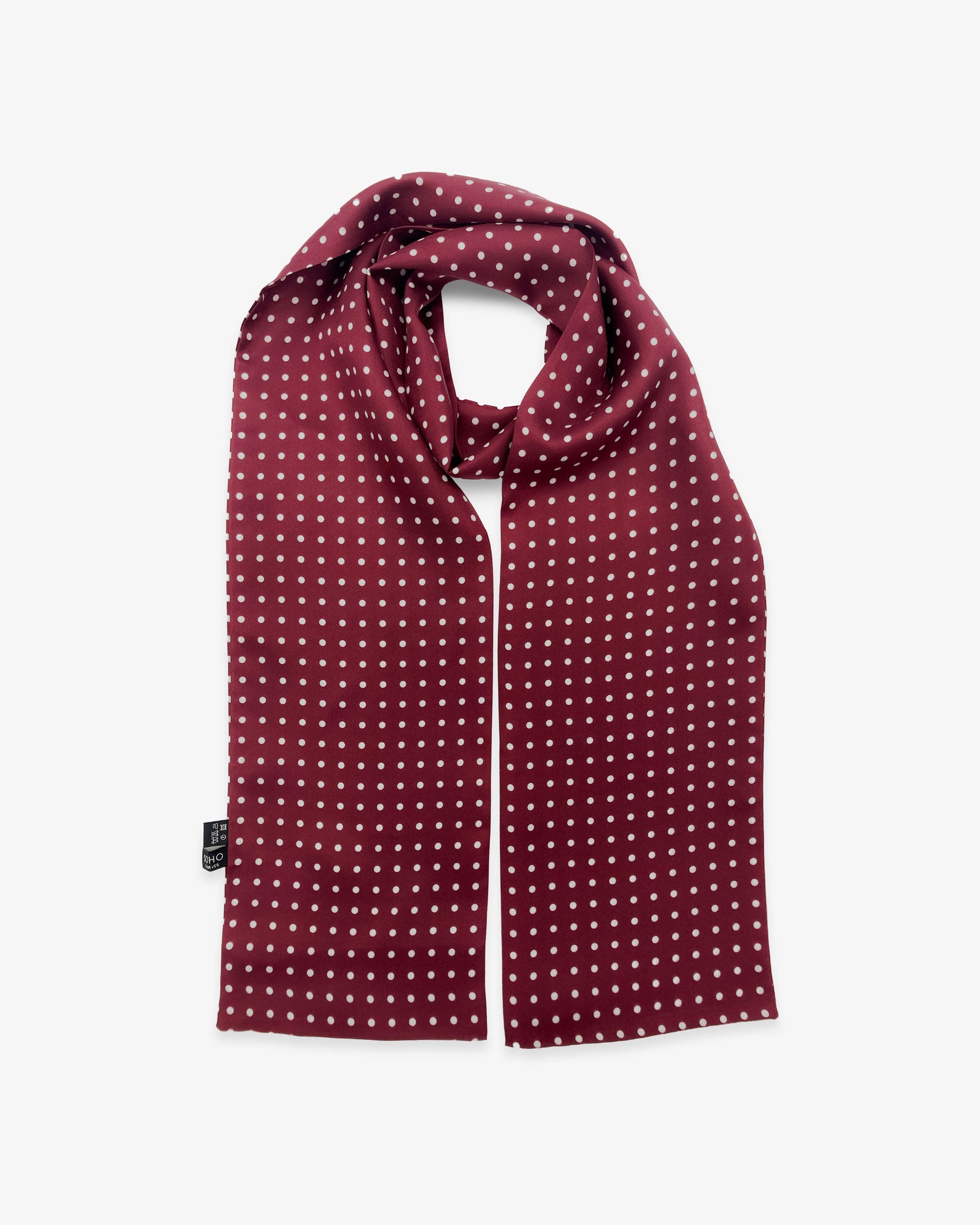 The Sapporo pure silk scarf looped in middle with both ends parallel showing the polka dot design in deep maroon with white dots.