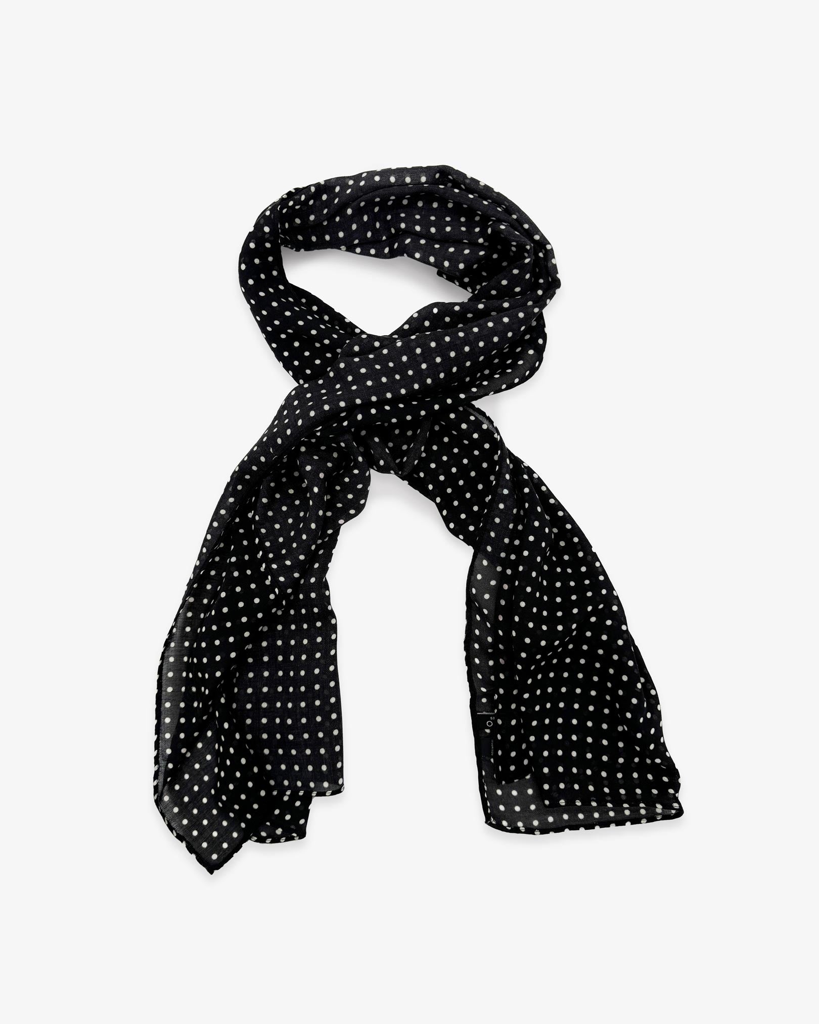 The Shinagwa wide scarf unravelled and looped in the middle, demonstrating the longer scarf length and polka dot patterns.