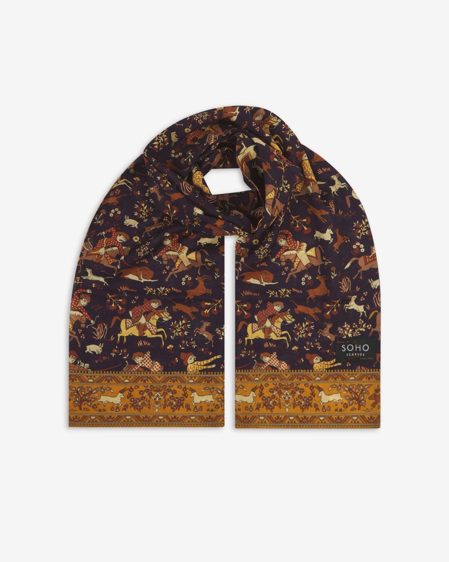 Premium indigo silk-wool scarf with hunting patterns. Unravelled and looped in the middle, presenting slightly longer and wider scarf dimensions, ornate border and ‘Soho Scarves’ label.