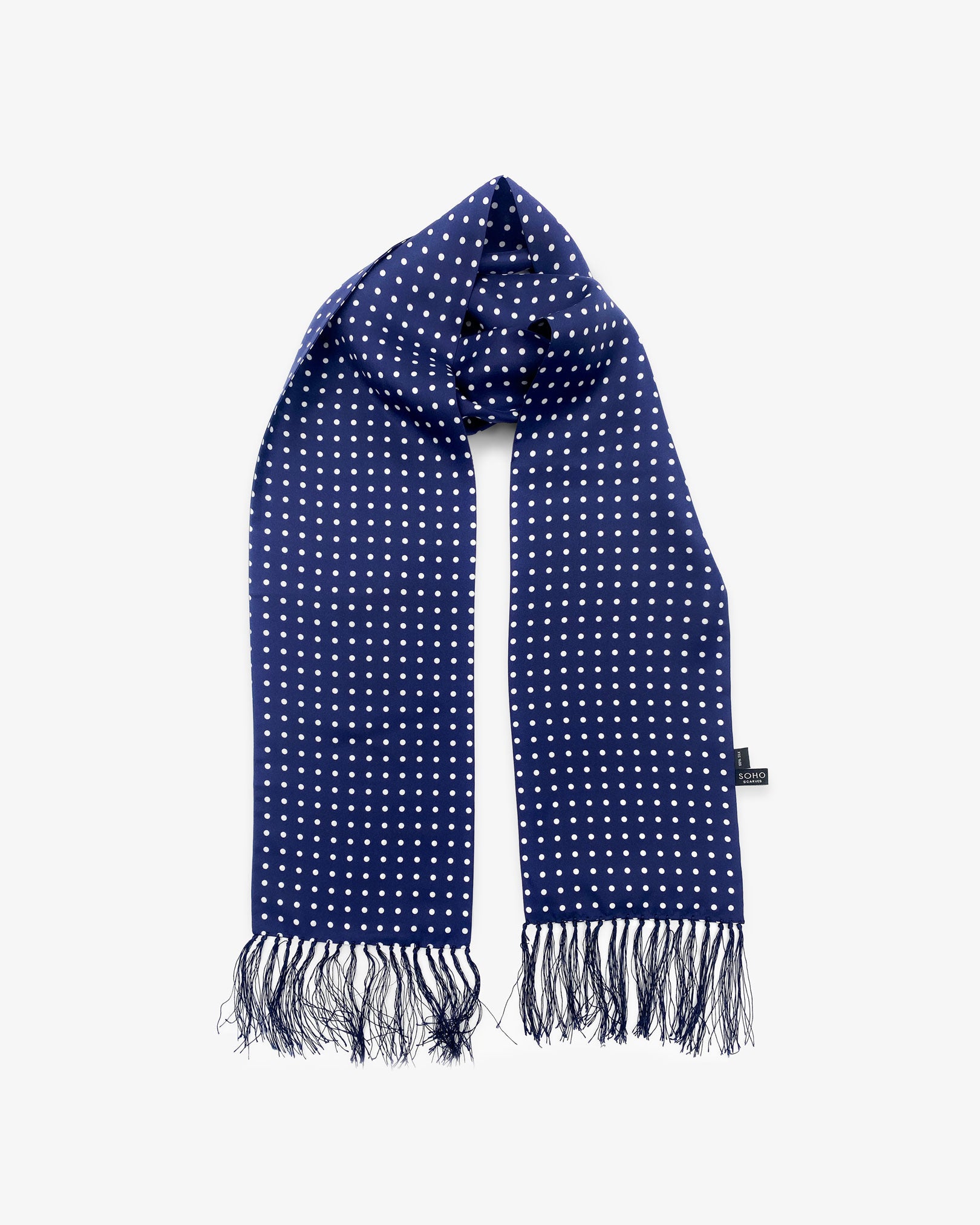Looped view of the 'Westminster' silk aviator scarf, clearly showing the timeless polka dot design in navy-blue with white spots with matching 3-inch fringe.