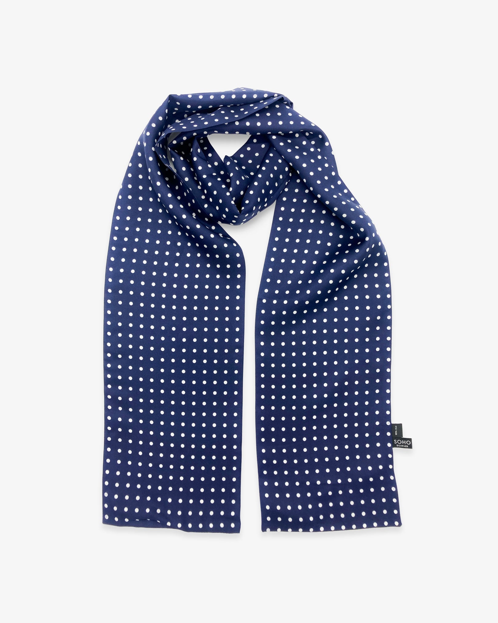 Looped view of the 'Westminster' silk scarf, clearly showing the timeless polka dot design in navy-blue with white spots.