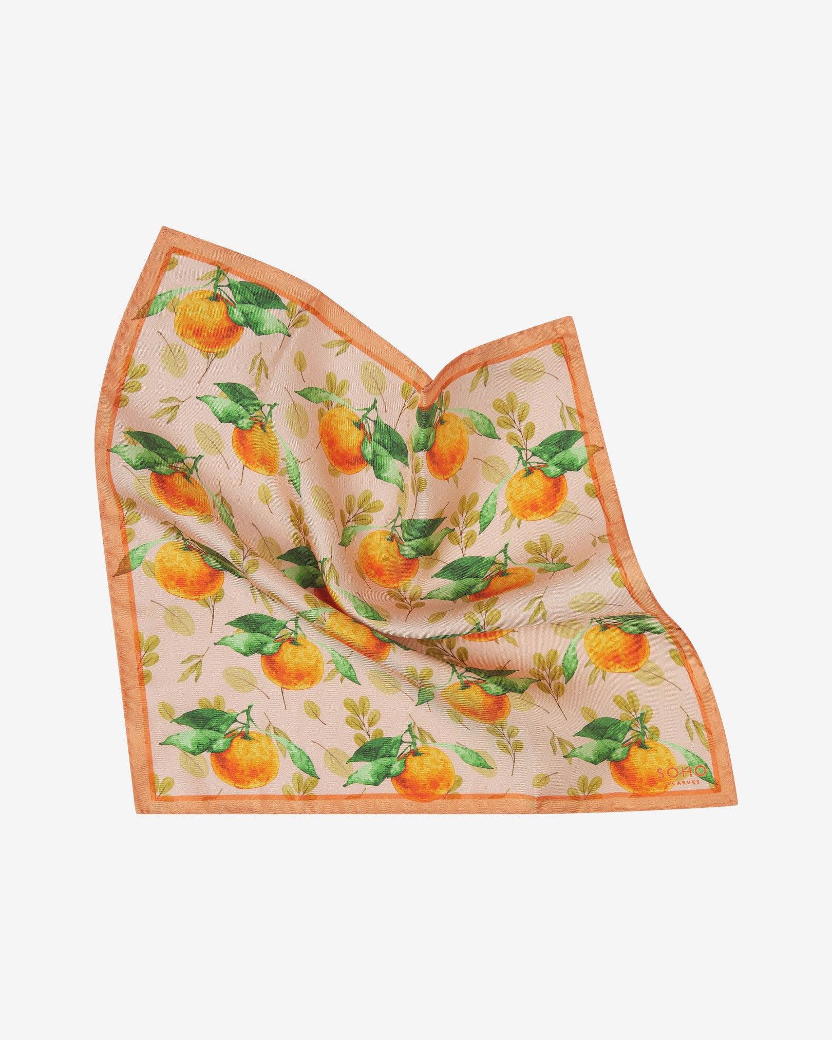 The 'Aire' pocket square pinched and twisted in the middle, showing the orange, green and peach design set on a cream-coloured background.
