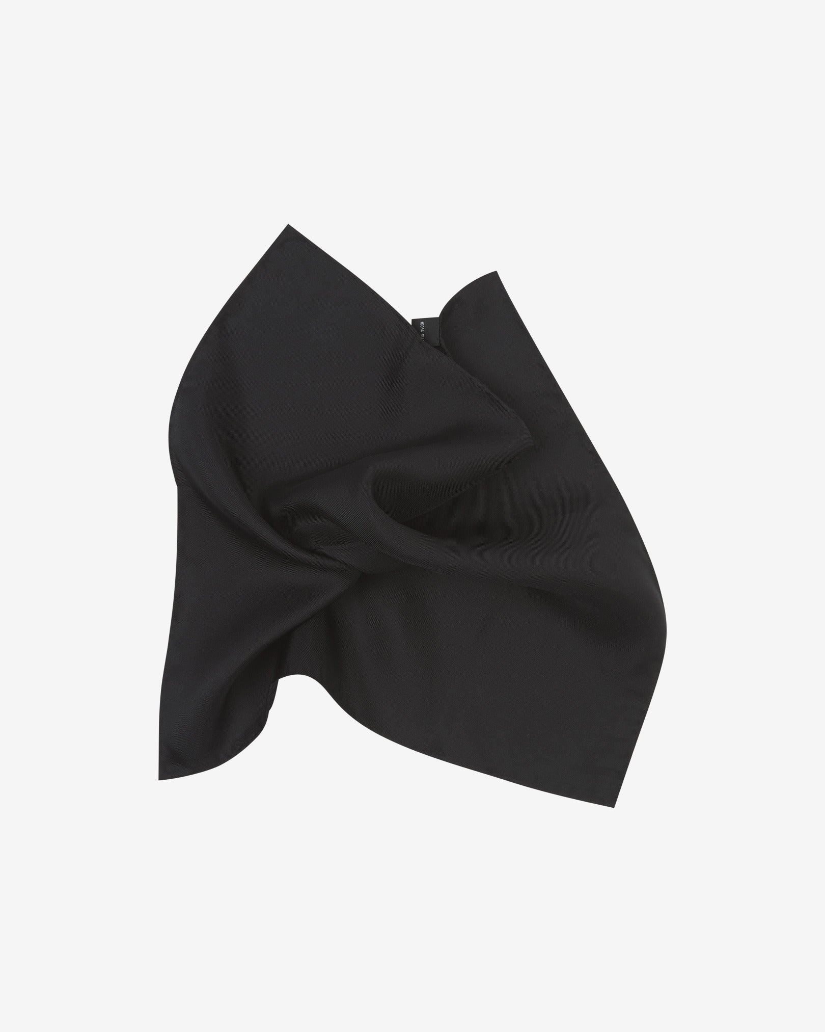 The plain, black silk pocket square pinched and twisted in the middle, presenting the sheen of the fine silk material.