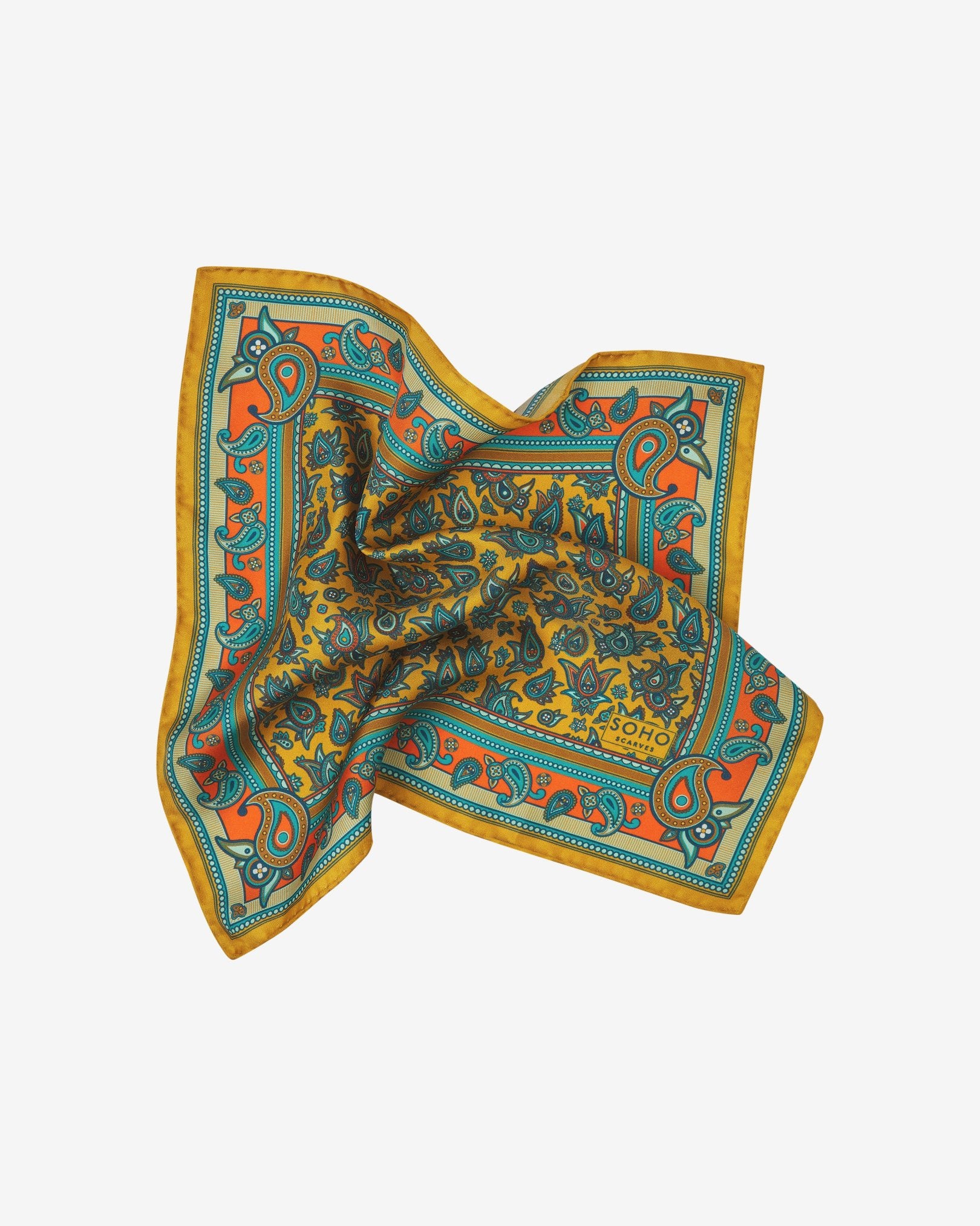 The 'Buttermere' pocket square pinched and twisted in the middle, presenting the blue, blue-green, orange, and yellow paisley patterns against the sheen of the fine silk material.