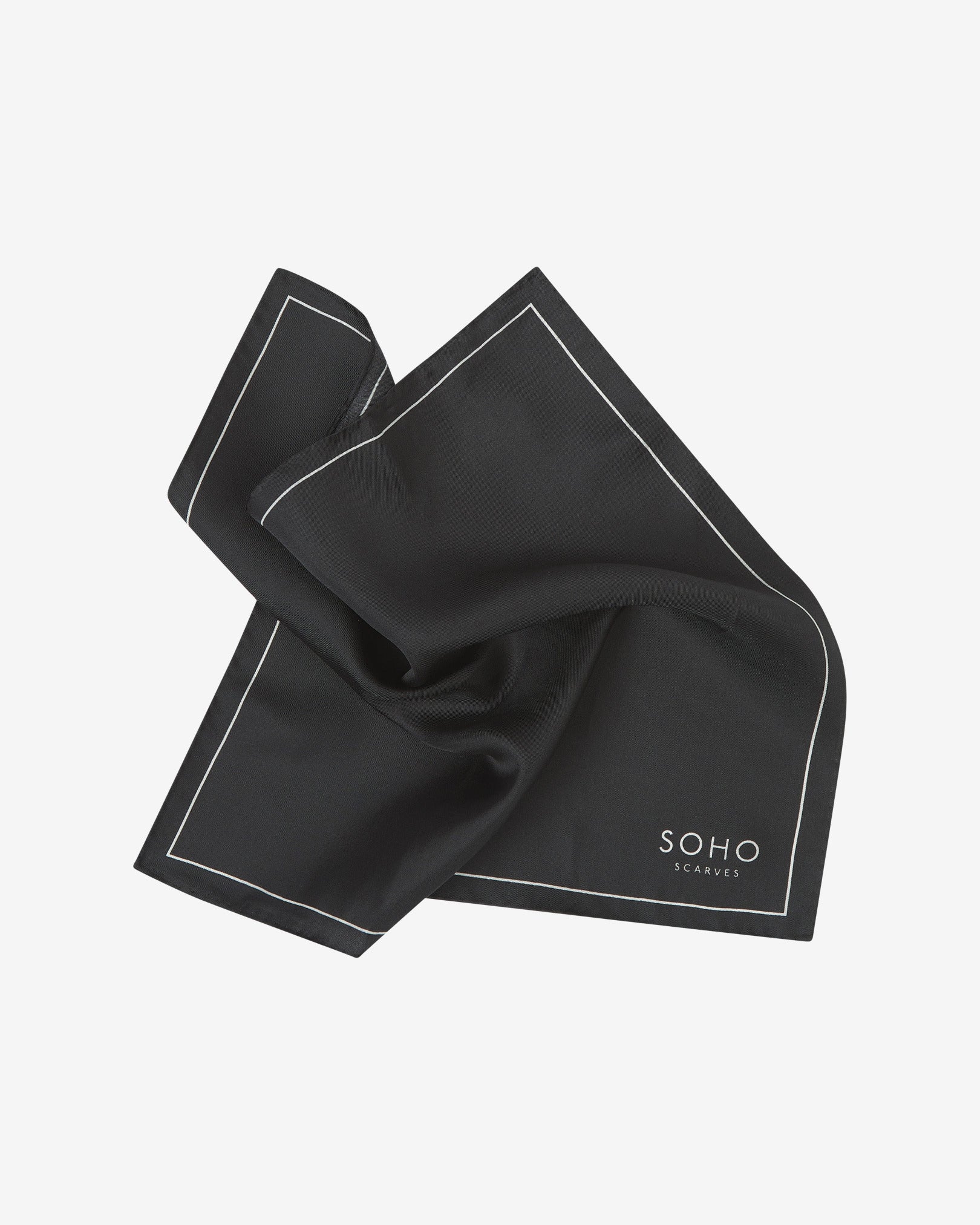 The plain, black silk pocket square pinched and twisted in the middle, presenting the sheen of the fine silk material.