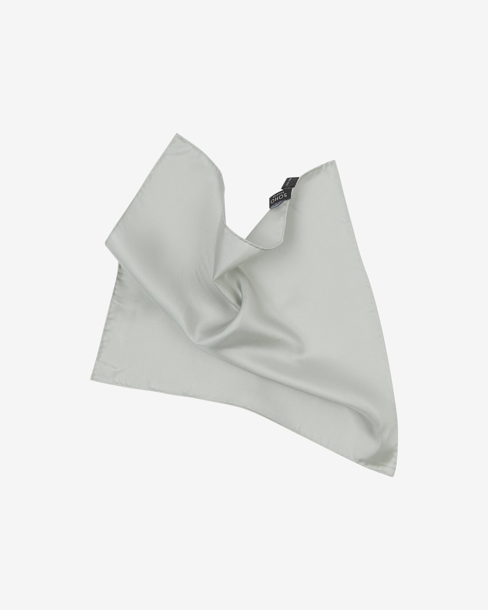 The plain, silver silk pocket square pinched and twisted in the middle, presenting the sheen of the fine silk material.