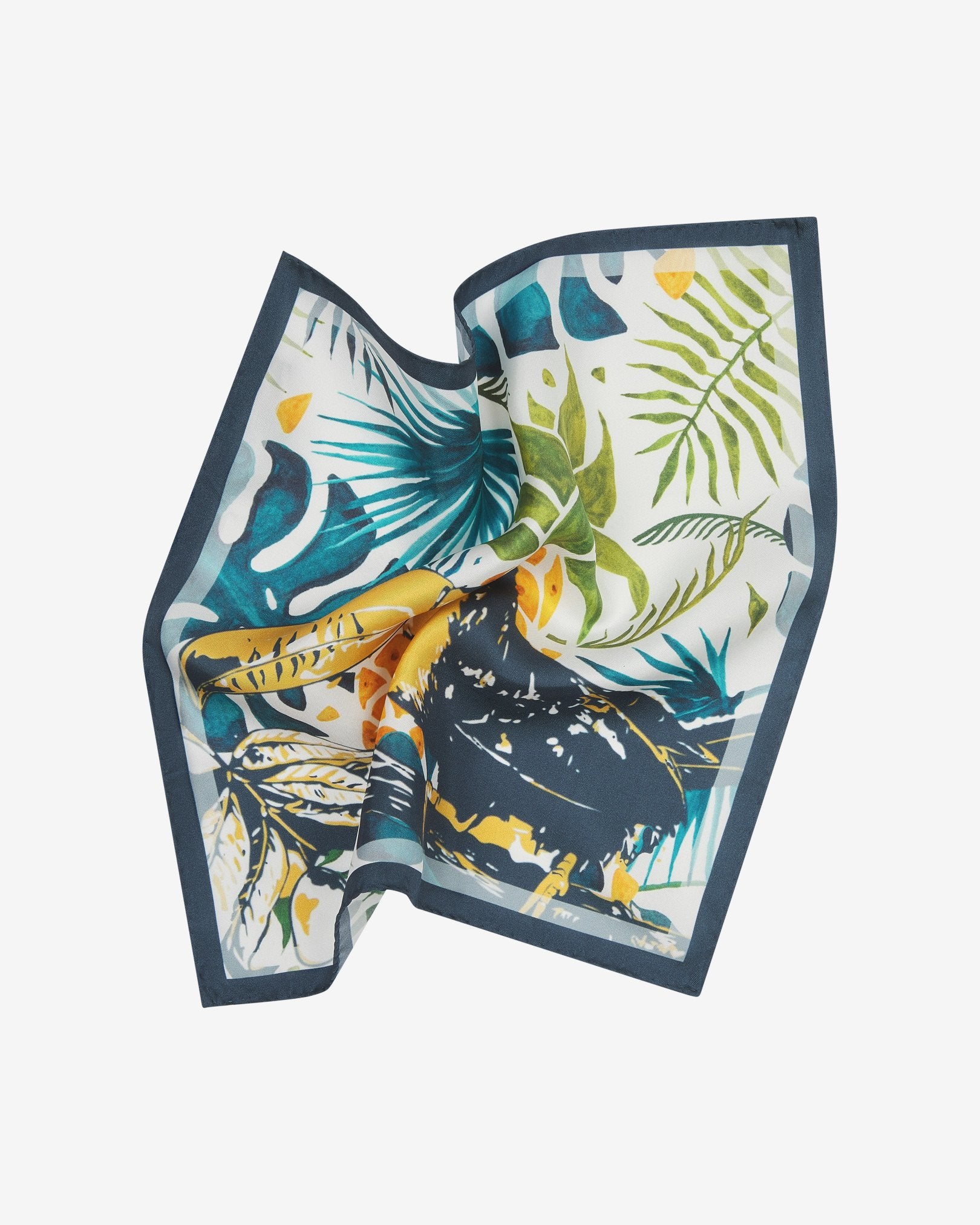 The 'Tees' silk pocket square pinched and twisted in the middle, showing the playful toucan bird motif framed with a blue border.