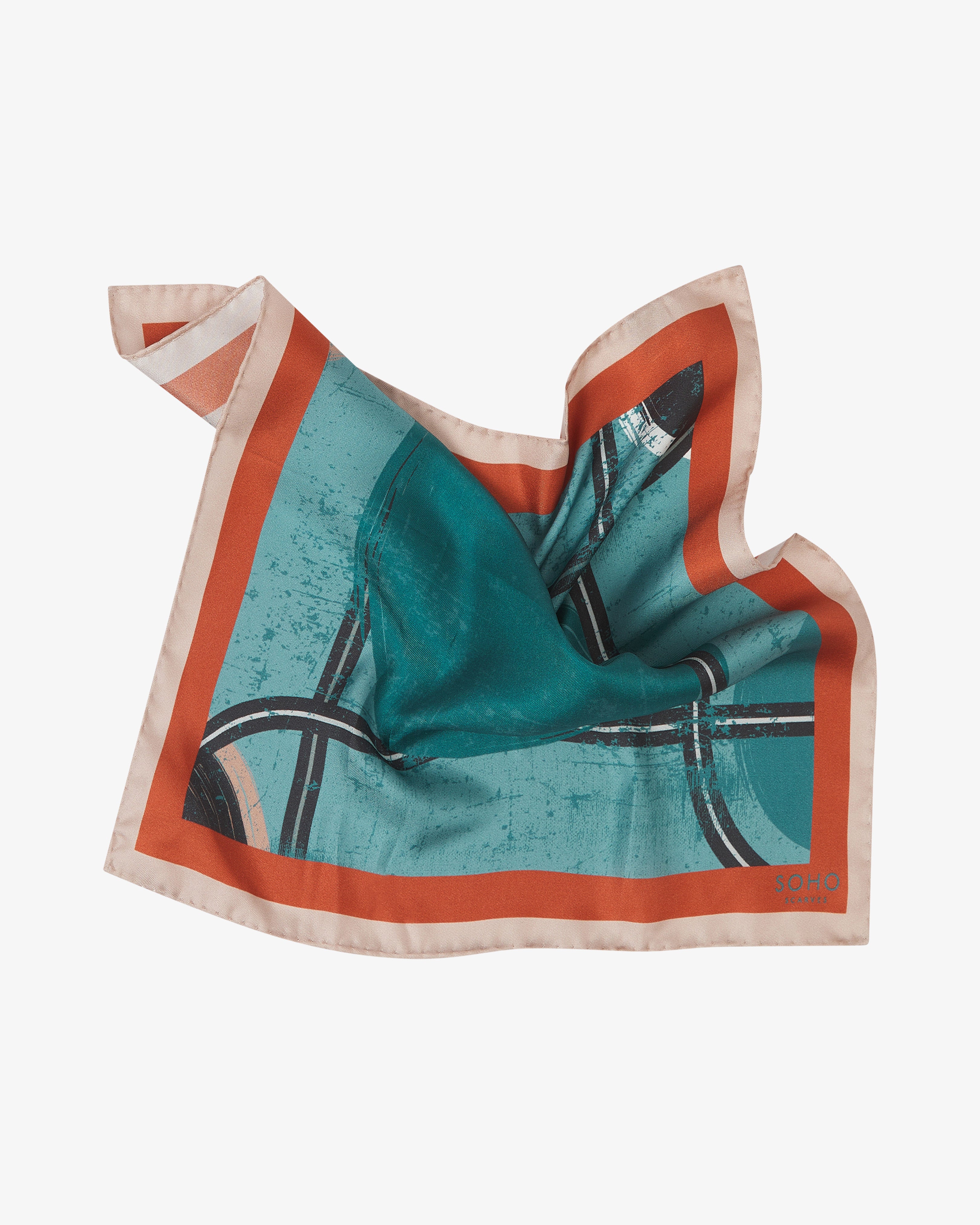 The 'Trent' pocket square pinched and twisted in the middle, showing the blue-green, peach and charcoal design.