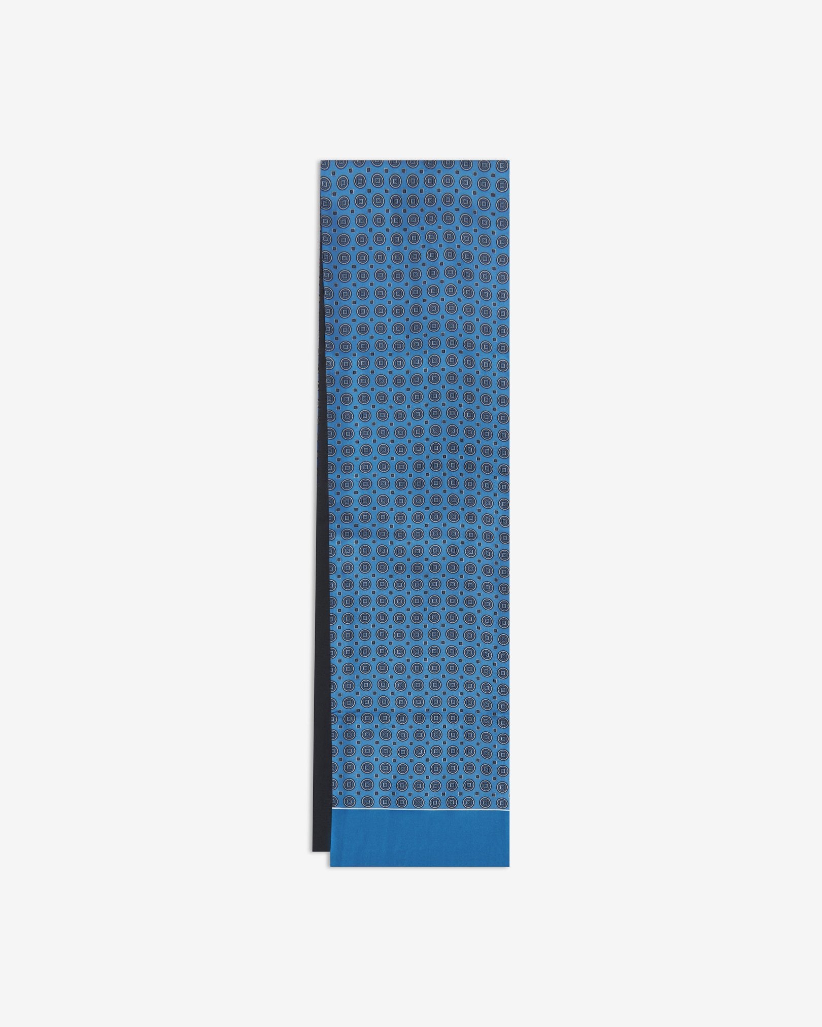 The Kyoto dress scarf arranged in a rectangular shape displaying the blue fabric with circles and small squares pattern and the fine woollen underside.