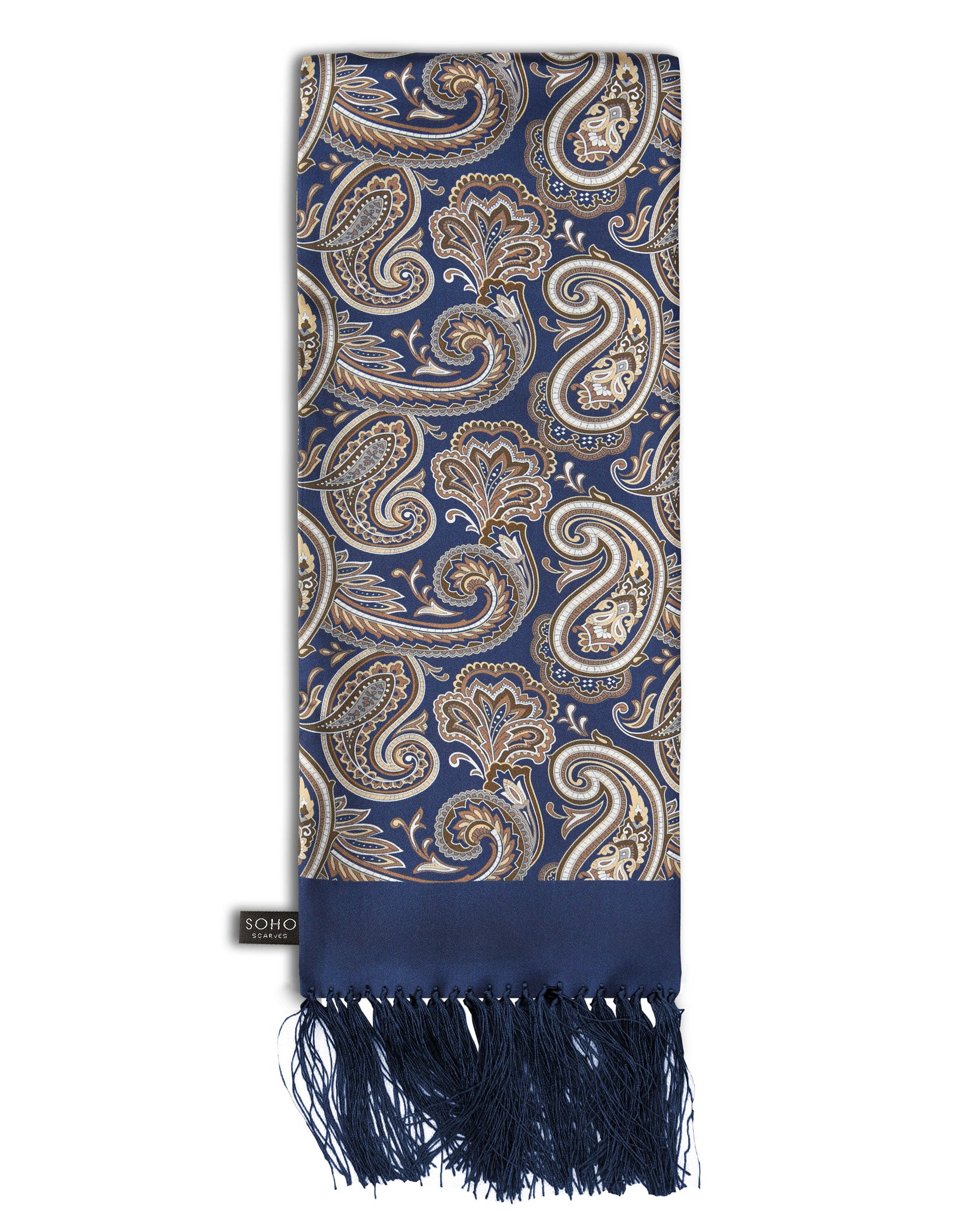 'The Redmond Aviator' deep blue silk scarf with large gold and cream paisley patterns, arranged in a rectangular shape, clearly showing the dark-blue 3-inch fringe and the 'Soho Scarves' label on the left edge.