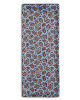 'The Regent' paisley polyester scarf arranged in a rectangular shape, clearly showing the light blue coloured fabric with paisley patterns and highlighted with red and navy-blue accents.