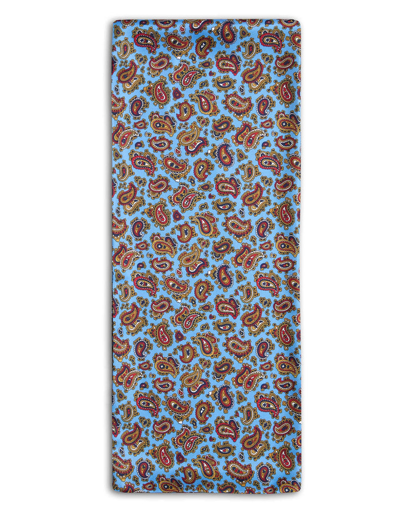 'The Regent' paisley polyester scarf arranged in a rectangular shape, clearly showing the light blue coloured fabric with paisley patterns and highlighted with red and navy-blue accents.