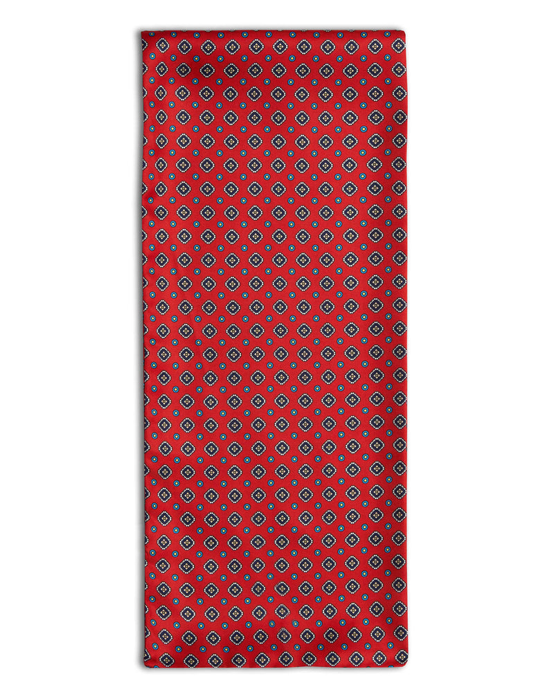 'The Romilly' geometric red polyester scarf arranged in a rectangular shape, clearly showing the multi-coloured patterns.