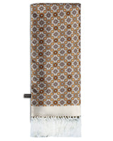 'The Wenatchee' cream silk aviator scarf arranged in a rectangular shape, clearly showing the orange, brown and light grey circular and floral-inspired geometric patterns, cream border, fringe and the 'Soho Scarves' label on the left edge.