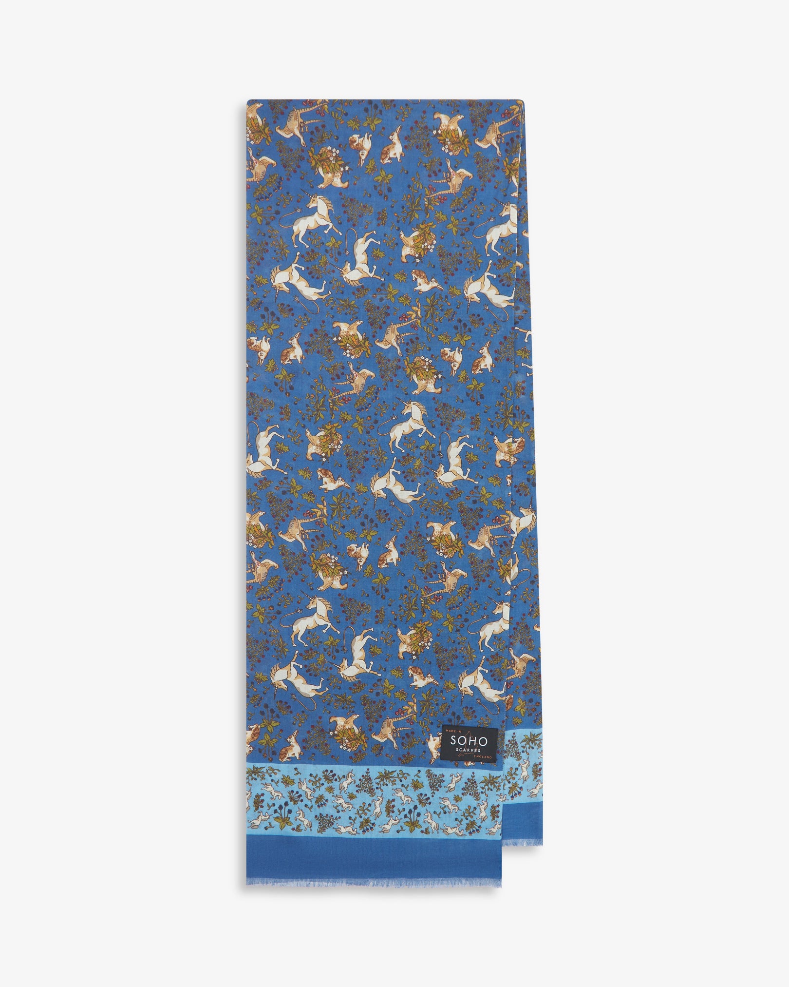 English-made silk and wool scarf arranged in a rectangular shape, displaying the repeating multicoloured unicorns, hares and pheasants with sky blue eyelash fringing.