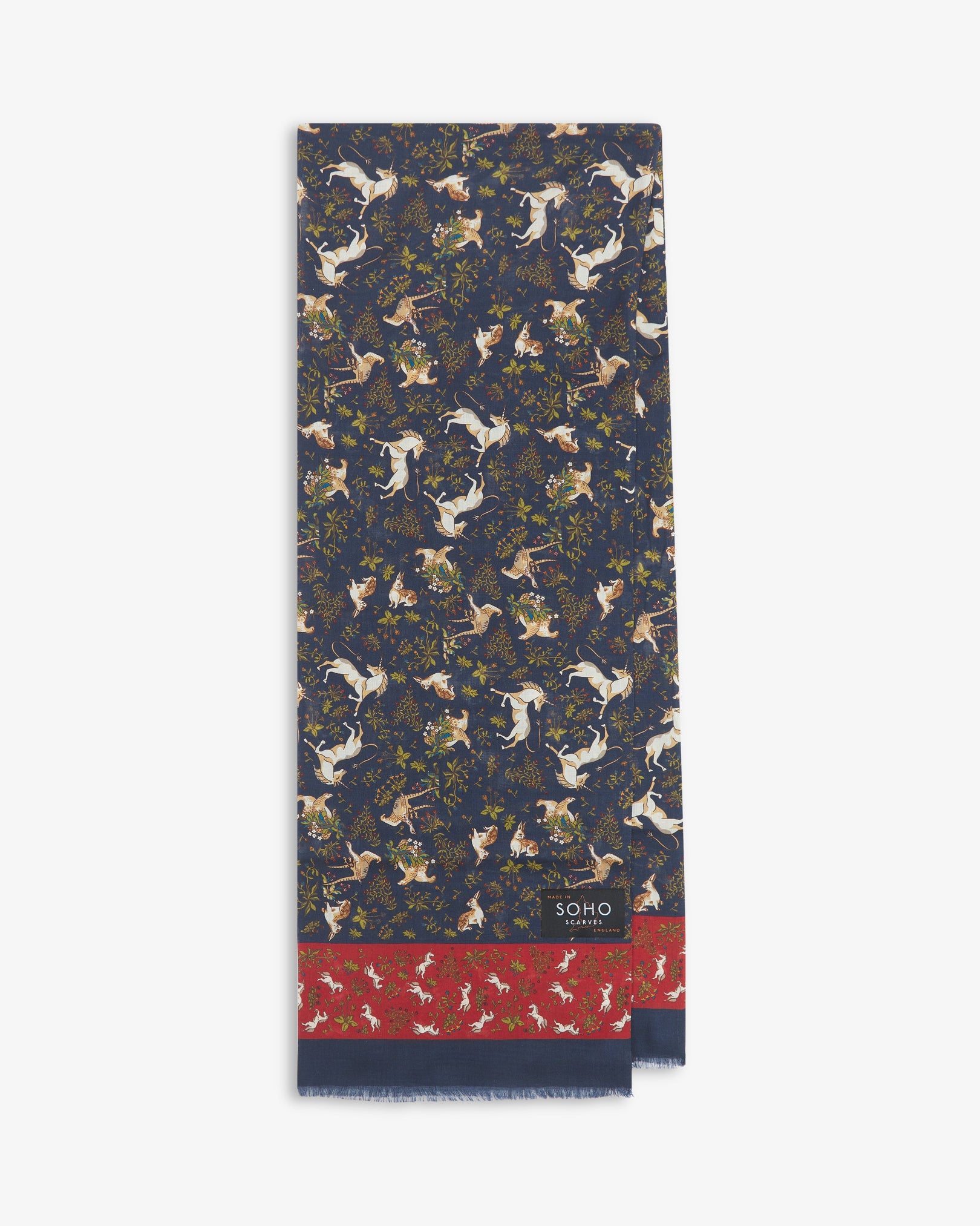 English-made silk and wool scarf arranged in a rectangular shape, displaying the repeating multicoloured unicorns, hares and pheasants with dark blue eyelash fringing.