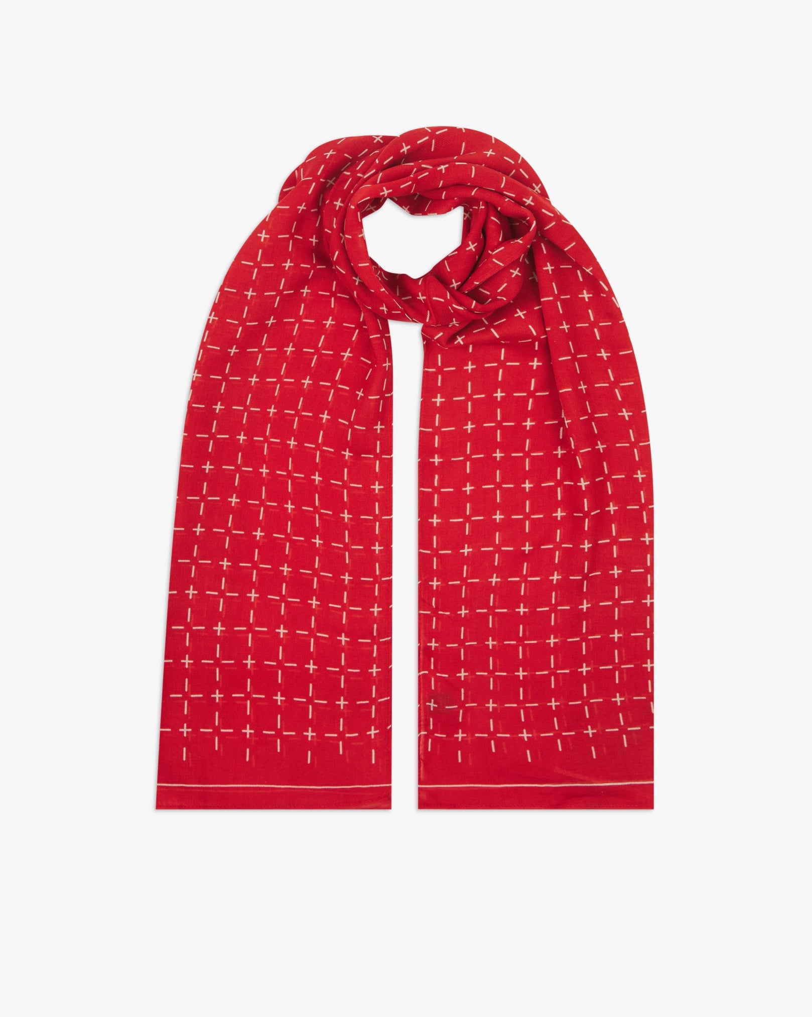 The 'Crosses' red bohemian wide scarf looped with both ends parallel, showcasing a neat geometric grid of white dashes and crosses on a bright red background across the soft modal and wool blend fabric.