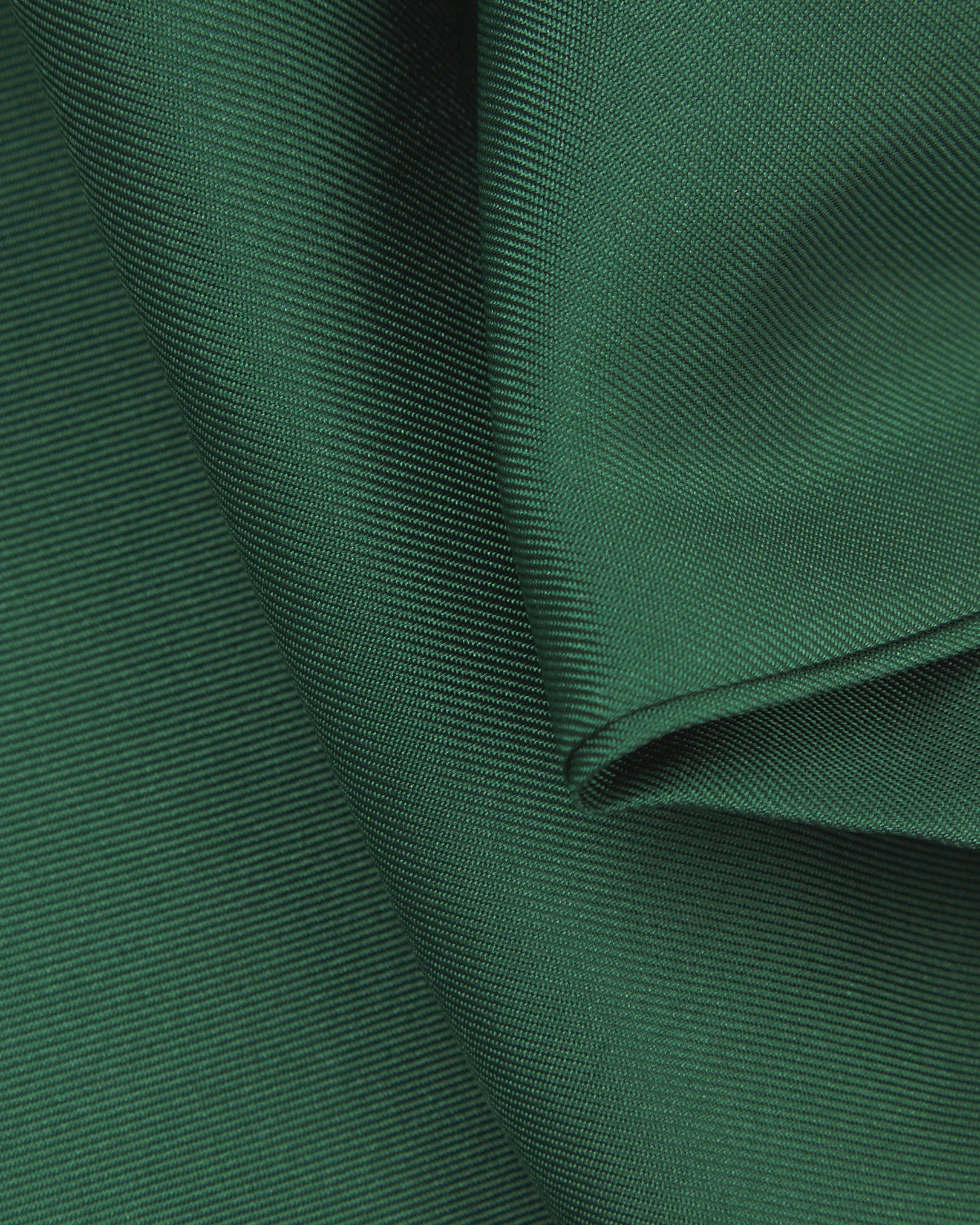 A ruffled close-up of the green double Ascot from Soho Scarves, presenting a closer view of the silk fabric and sheen.