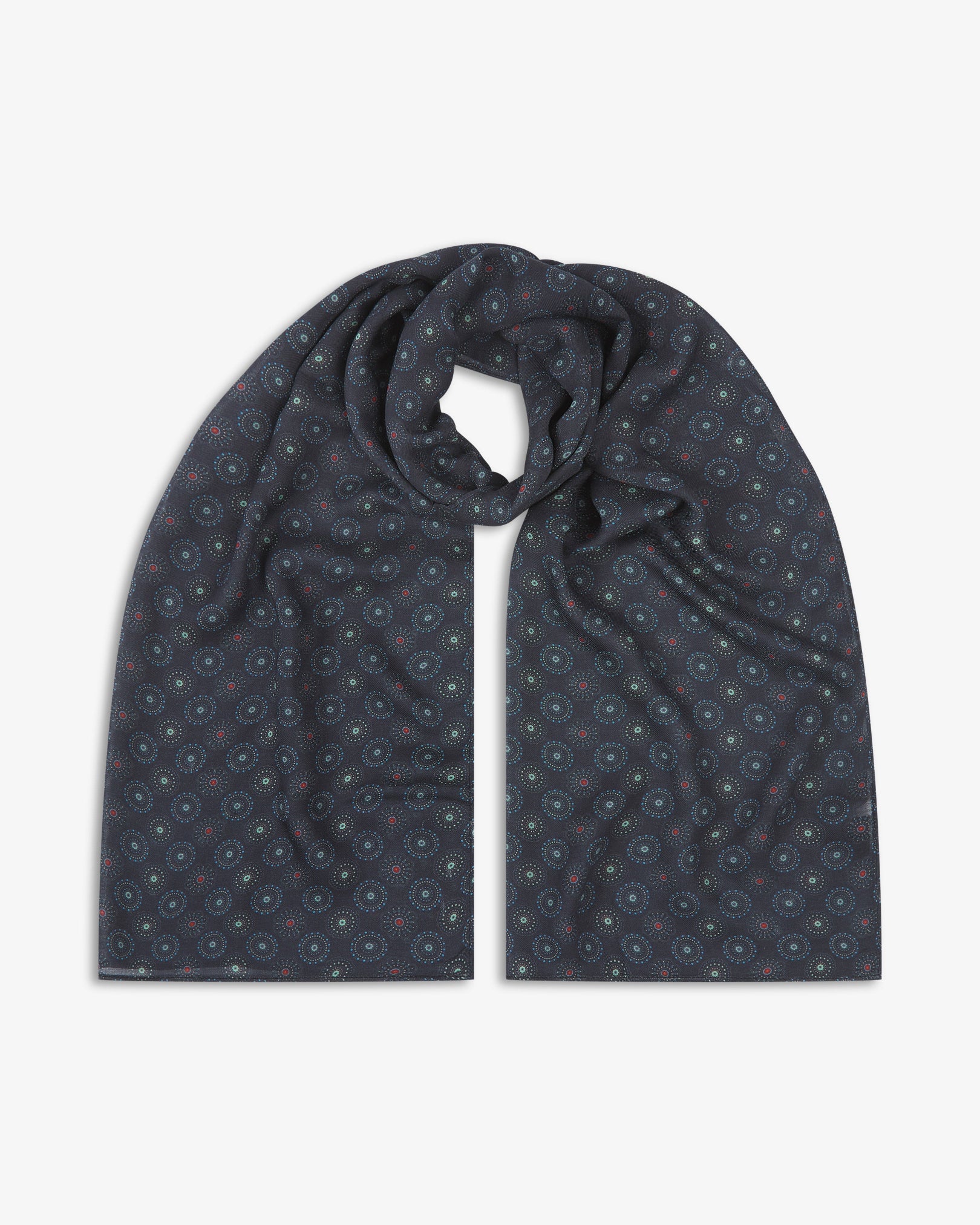 The Seattle 'Gardenia' bohemian wide scarf looped with both ends parallel, showcasing intricate circular motifs in blue and mint green on a black background with subtle red accents across the soft modal and wool blend fabric.