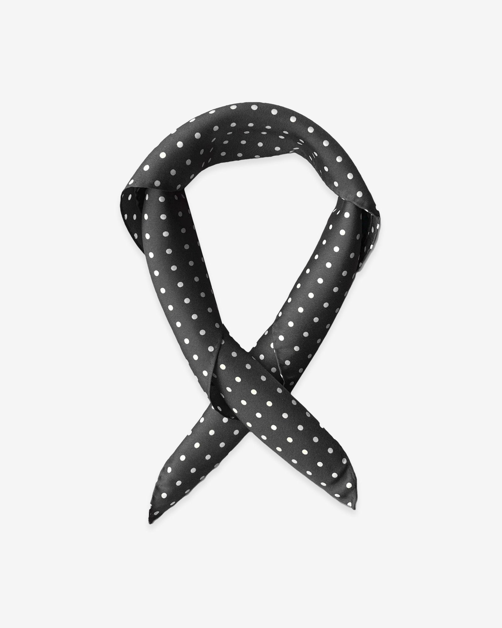 The 'Shinagwa' black silk scarf with white polka-dot patterns.  Presented in a rolled loop against a white background.