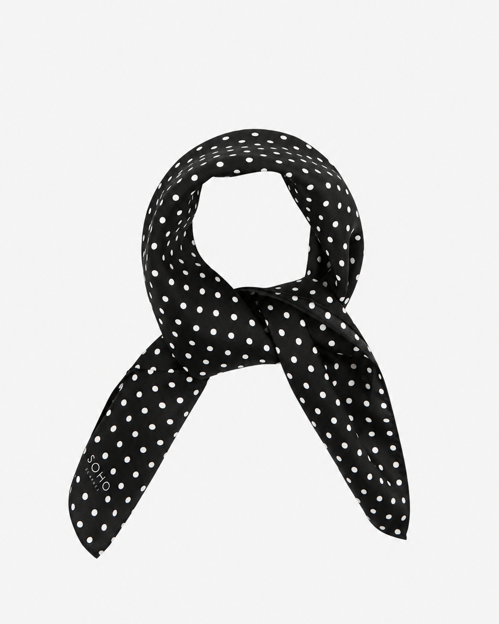 The 'Shinagwa' black silk scarf with white polka-dot patterns.  Presented in a rolled loop against a white background.