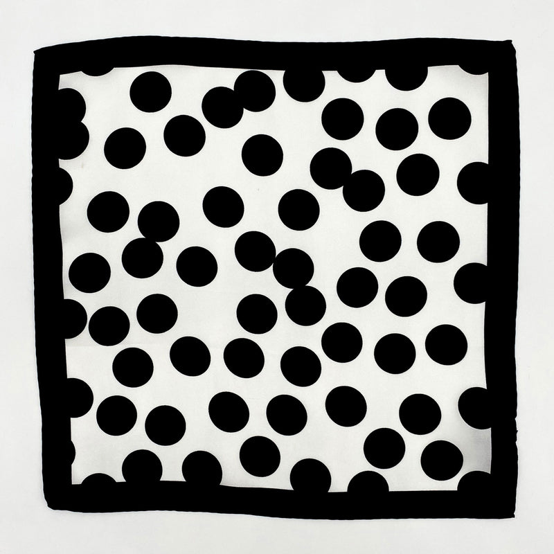 Completely unfolded monochrome silk pocket square showing the entirity of the polka-dot patterns and black border.
