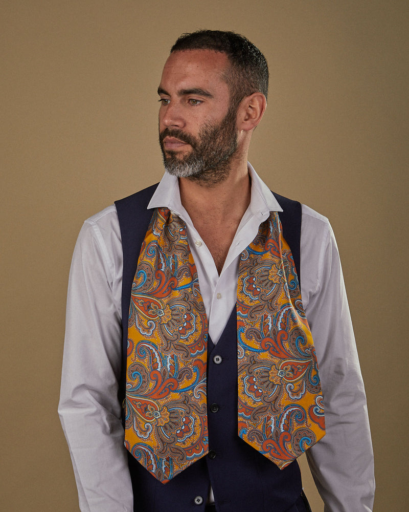 Wearing a Carnaby silk Double Ascot tie from SOHO Scarves with head turned to his right. Tie draped around neck hanging loose.