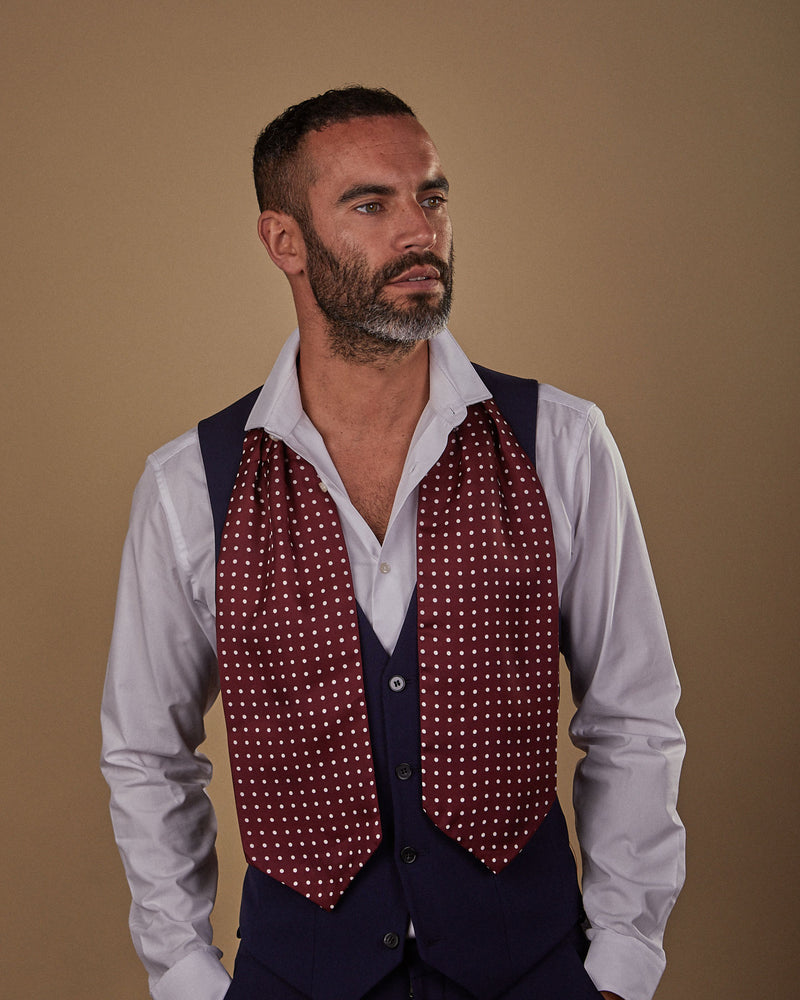 Front view wearing a Sapporo polka dot silk Double Ascot tie from SOHO Scarves, paired with white shirt and midnight blue waistcoat.
