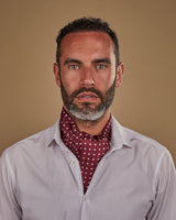 Wearing Sapporo polka dot silk double ascot tie knotted and tucked under white shirt.