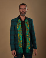 Front view wearing 'The Forks' silk aviator scarf from SOHO Scarves, paired with a black shirt and deep green chequered suit.