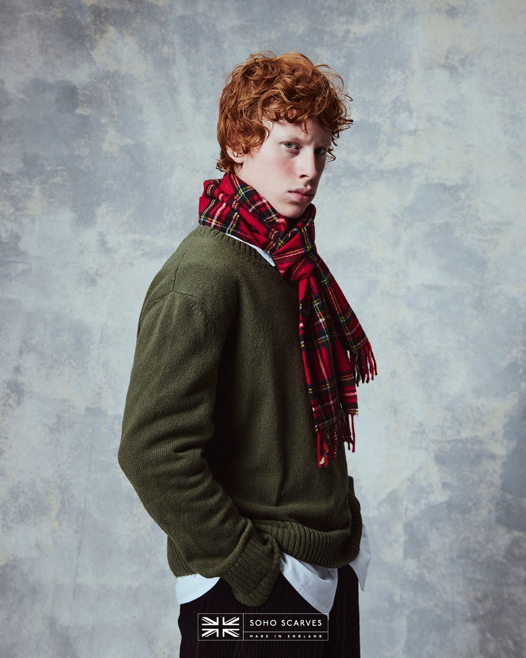 Side view of man wearing the Yorkshire-made, 'Highlands Tartan in Red' wool scarf from Soho Scarves.