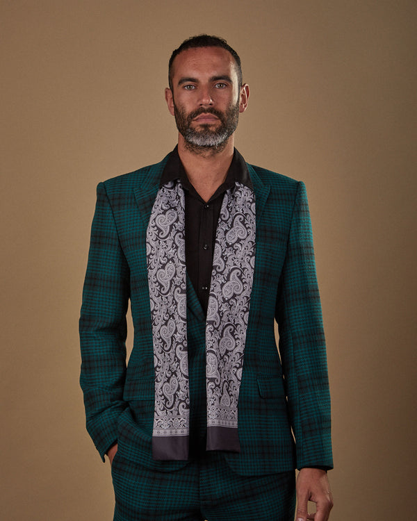 Front view wearing a 'Jaspar' paisley polyester scarf from SOHO Scarves, paired with a black shirt and deep green chequered suit.