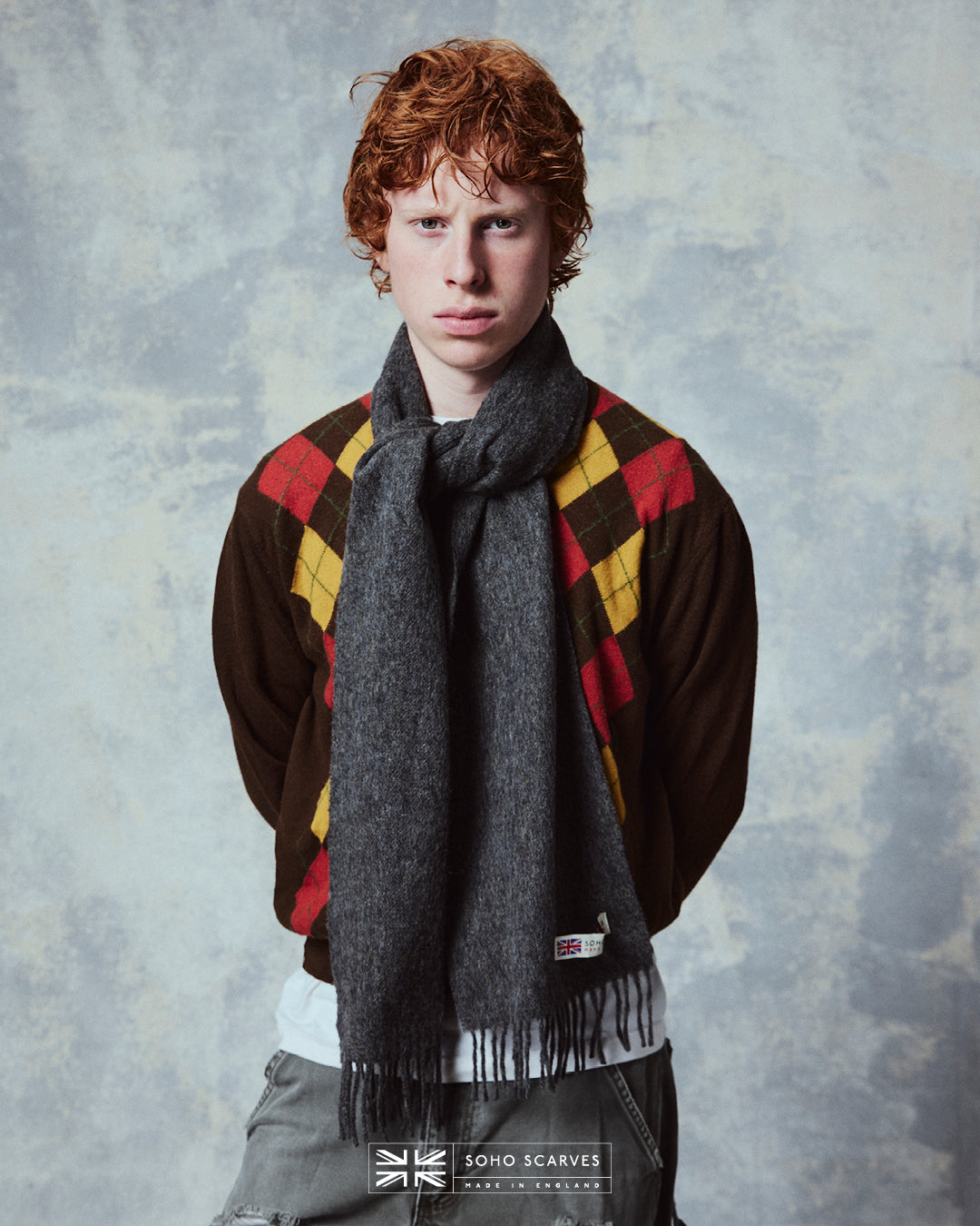 Top-half view of man wearing the Yorkshire-made, 'Lowlands in Grey' wool scarf from Soho Scarves.