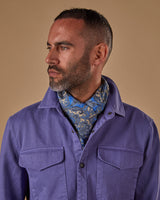 Head and shoulders view of model facing his right wearing 'The Piccadilly' blue-cream paisley dress scarf.