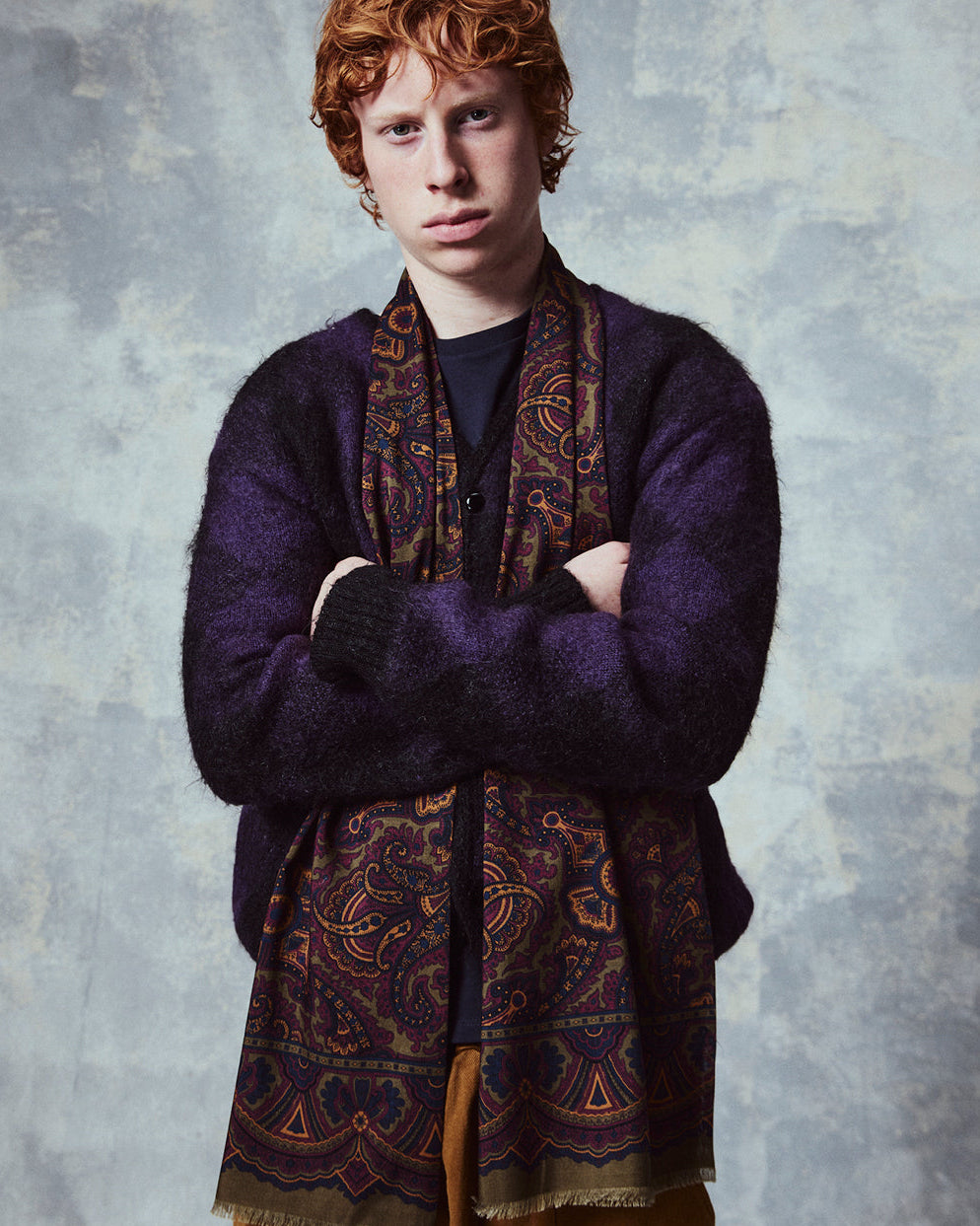 Top-half view of man wearing the English-made, 'Paisley in Highland Green' silk and wool scarf from Soho Scarves.
