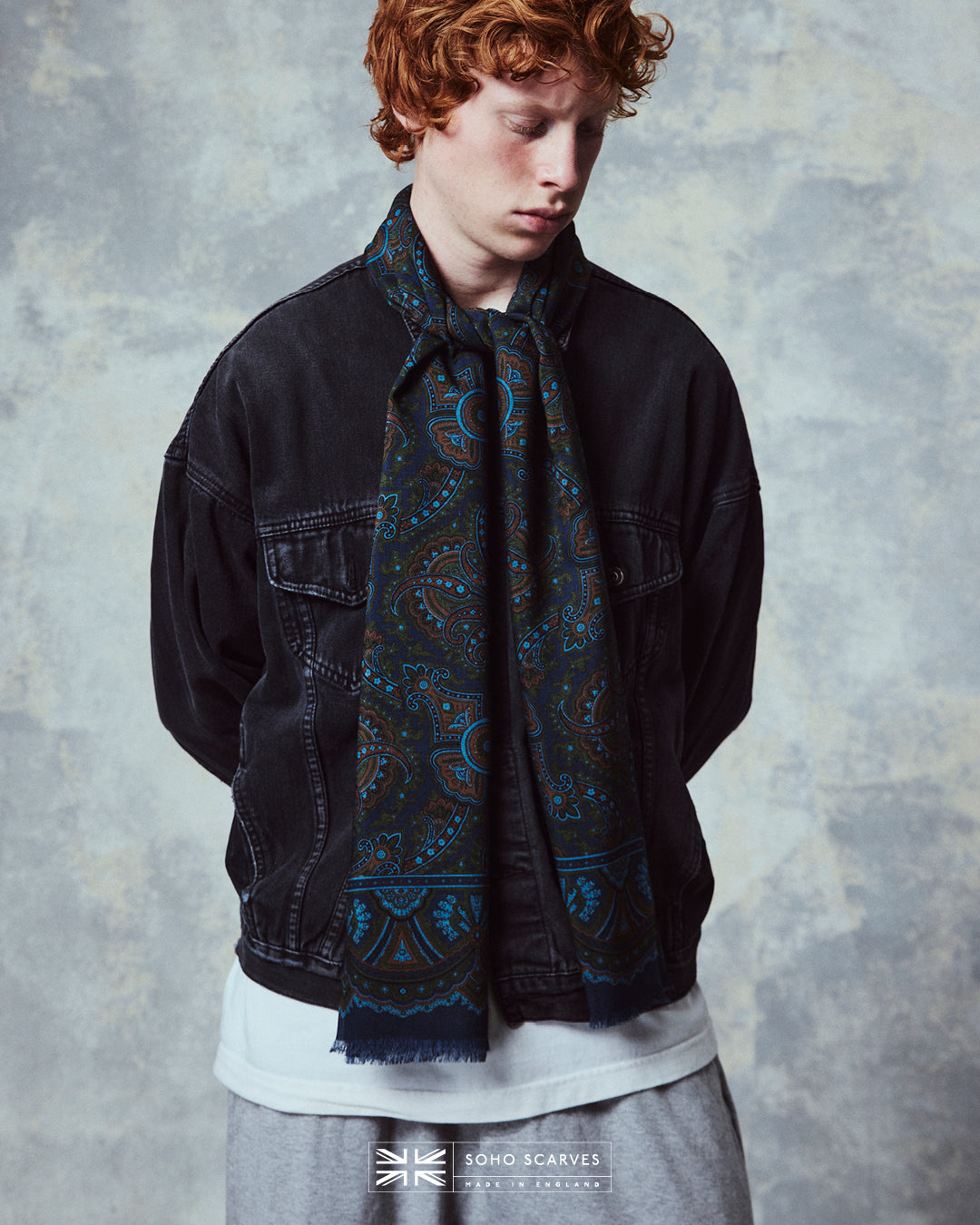 Top-half view of man wearing the English-made, 'Paisley in Navy' silk and wool scarf from Soho Scarves.