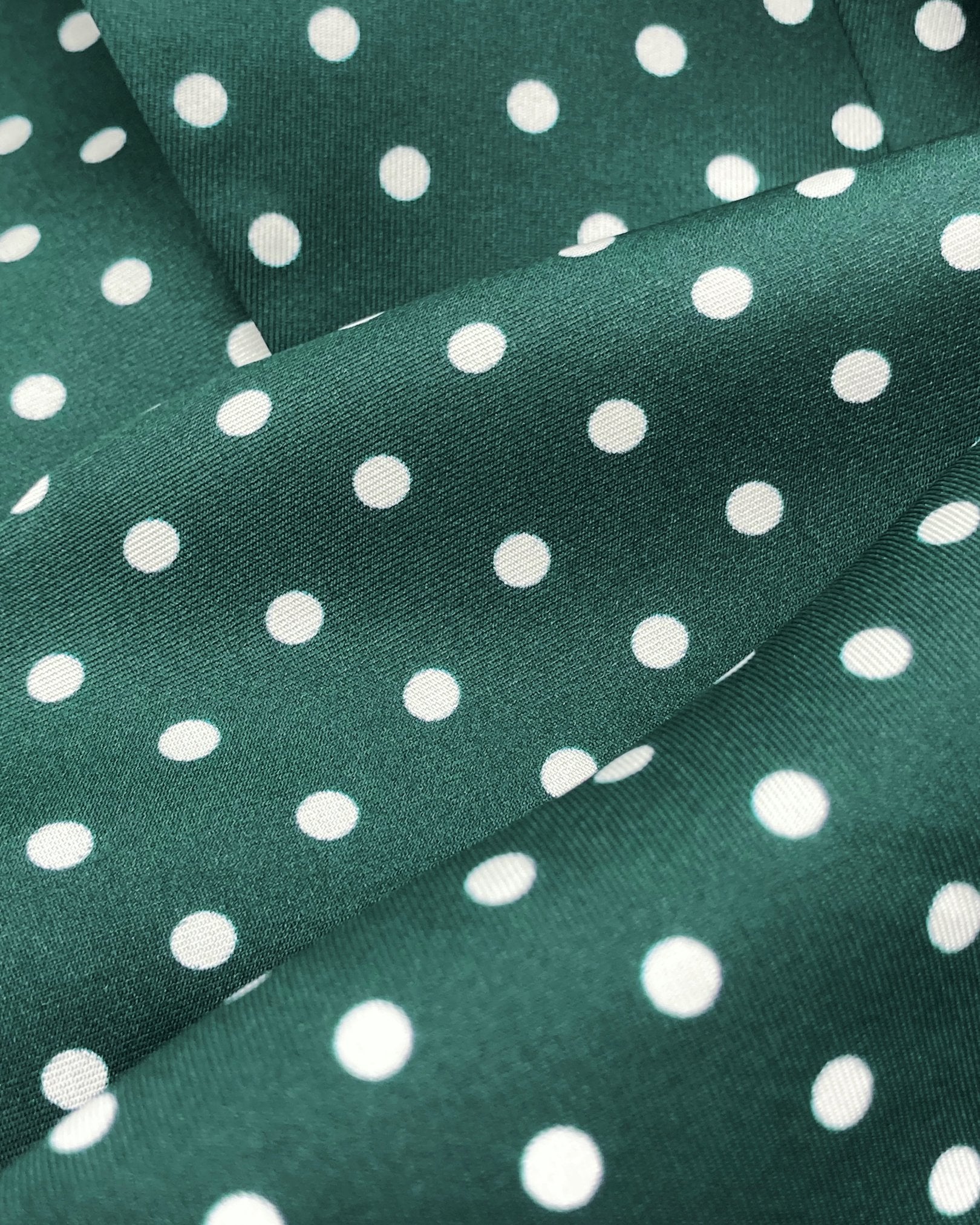 A ruffled close-up of the 'Westminster Rg' silk neckerchief, presenting a closer view of the silk fabric and the white polka-dot patterns.