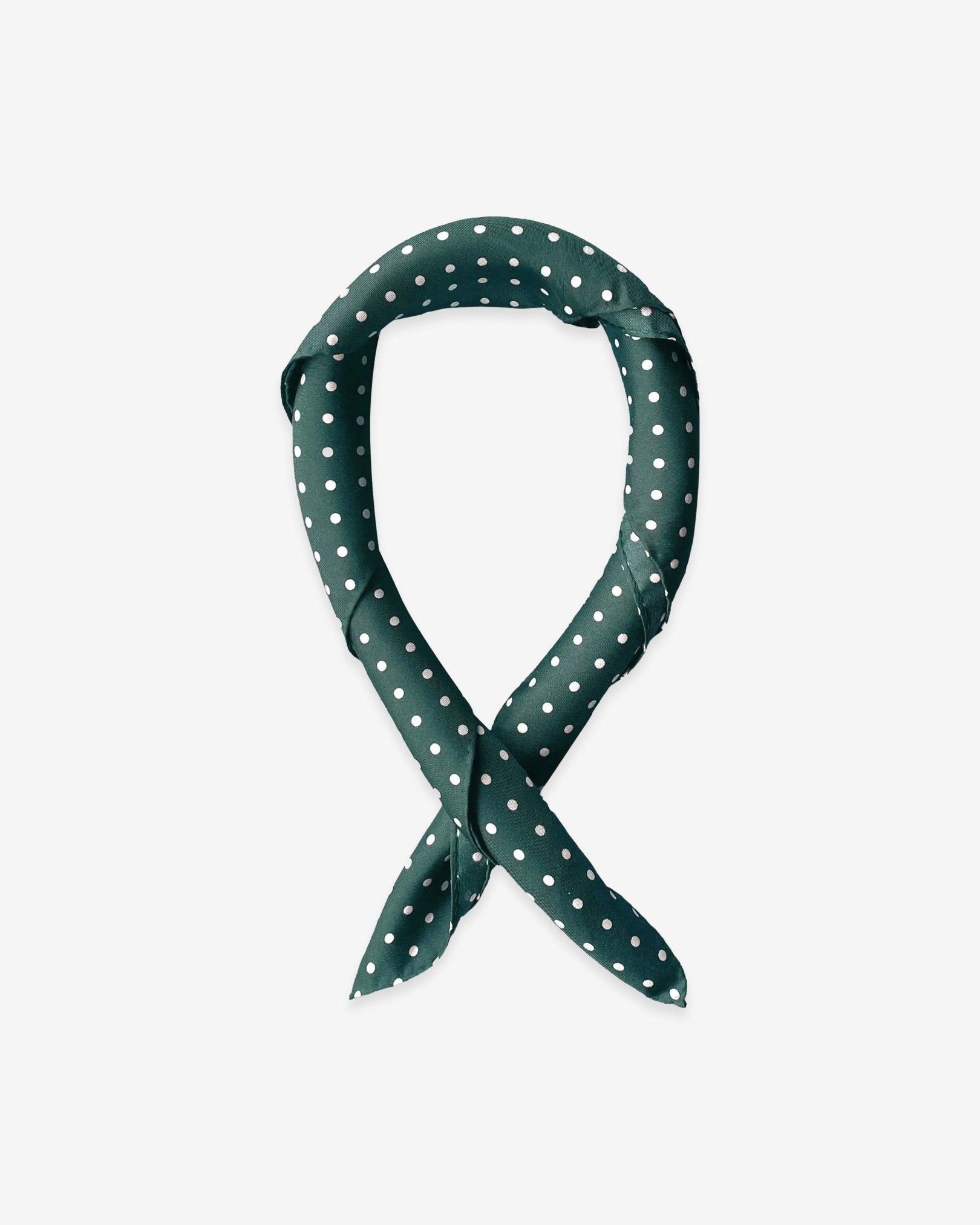 The 'Westminster Rg' racing green silk scarf with white polka-dot patterns.  Presented in a rolled loop against a white background.