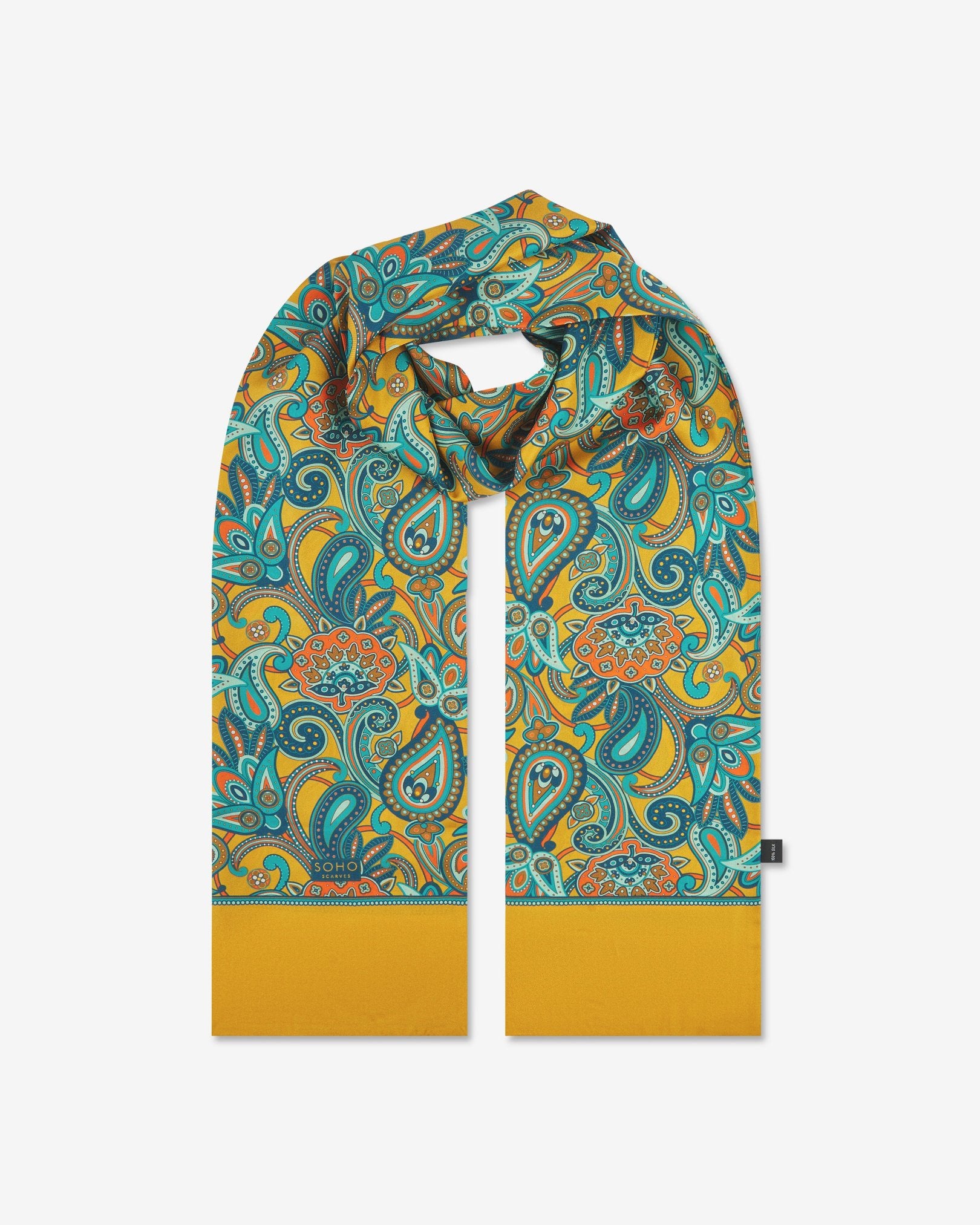 The 'Windermere' gold silk scarf looped with both ends parallel to effectively display the full repeat pattern of blue, blue-green, orange, and yellow paisley patterns on an gold background.